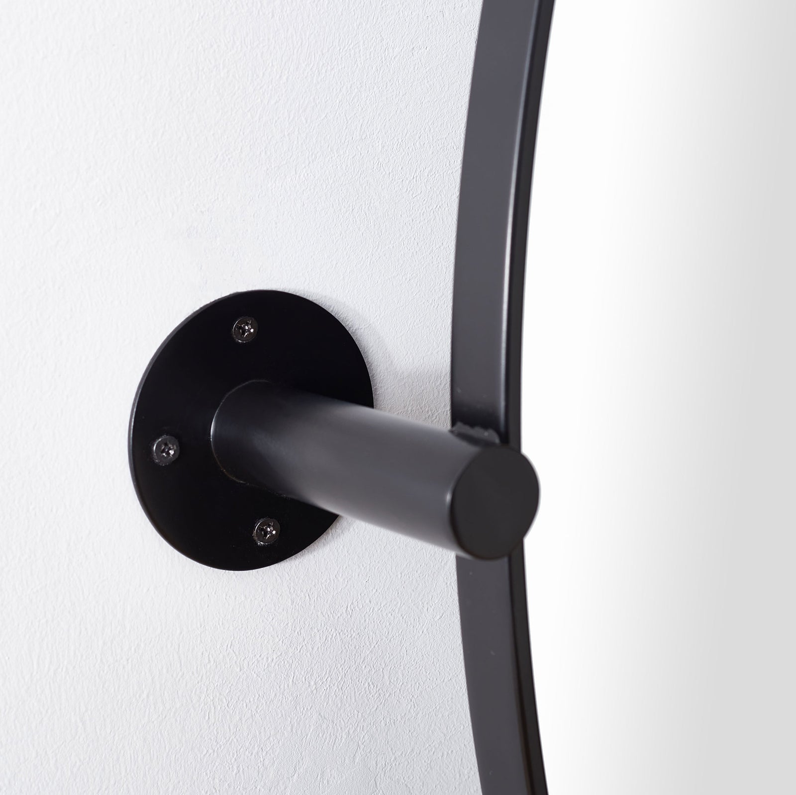 Visible screws secure the black wall plate that anchors the mirror's projecting metal arm || MRR2000B || detail_room