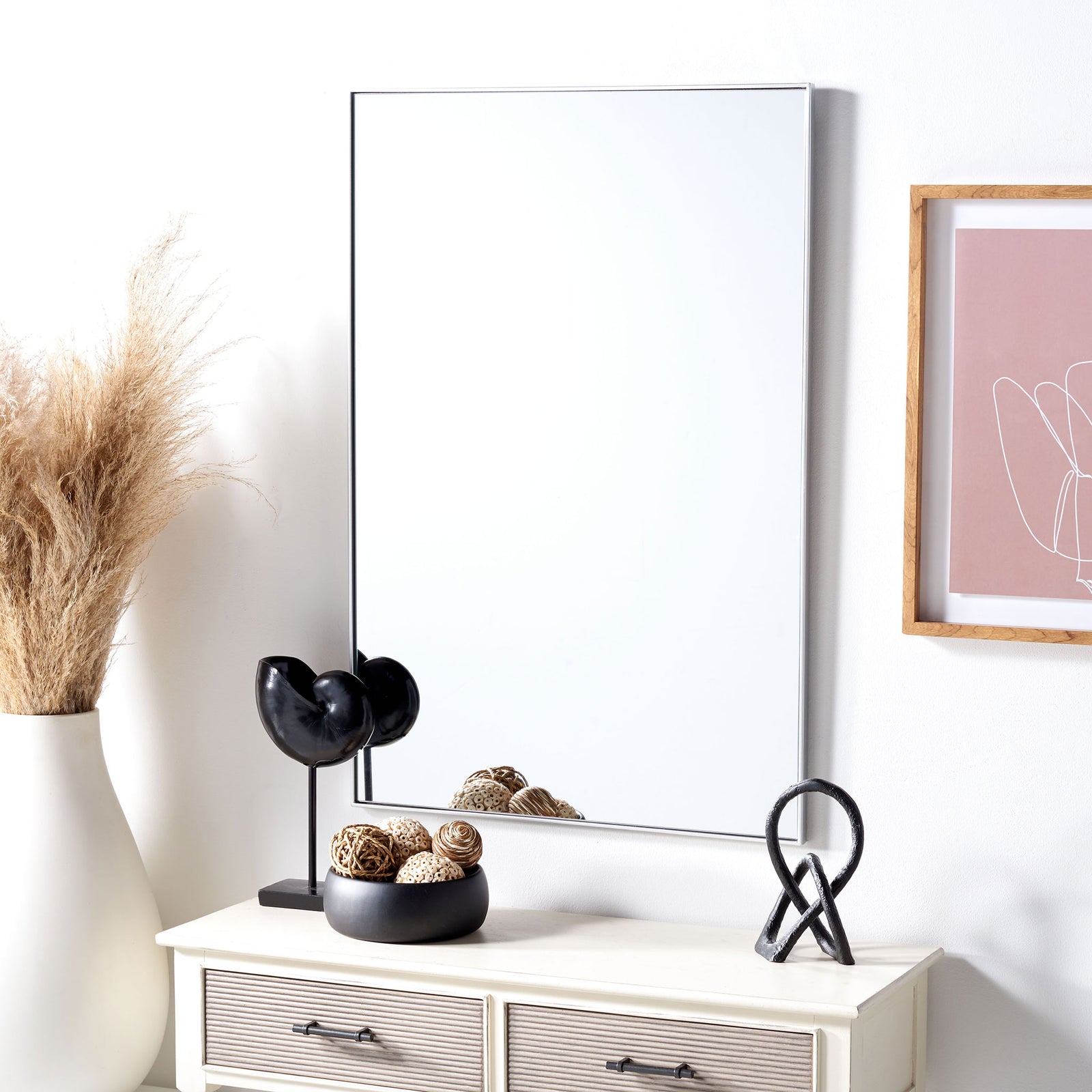 A tall silver-framed mirror brings a crisp, understated accent to the wall above a console. || MRR2011B || front_room