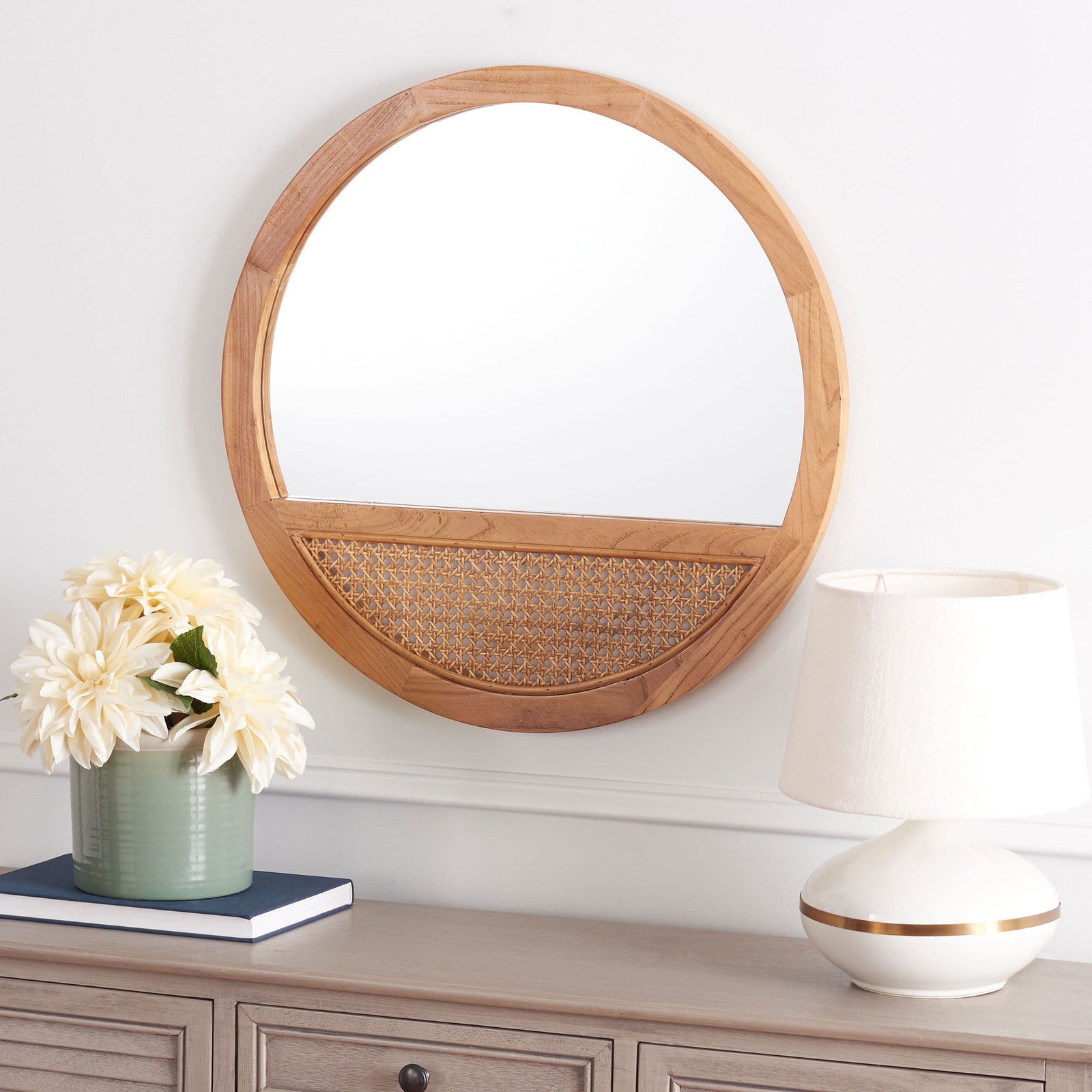 A round natural wood mirror with a woven cane inset brings warmth above a light wood console. || MRR2014B || front_room