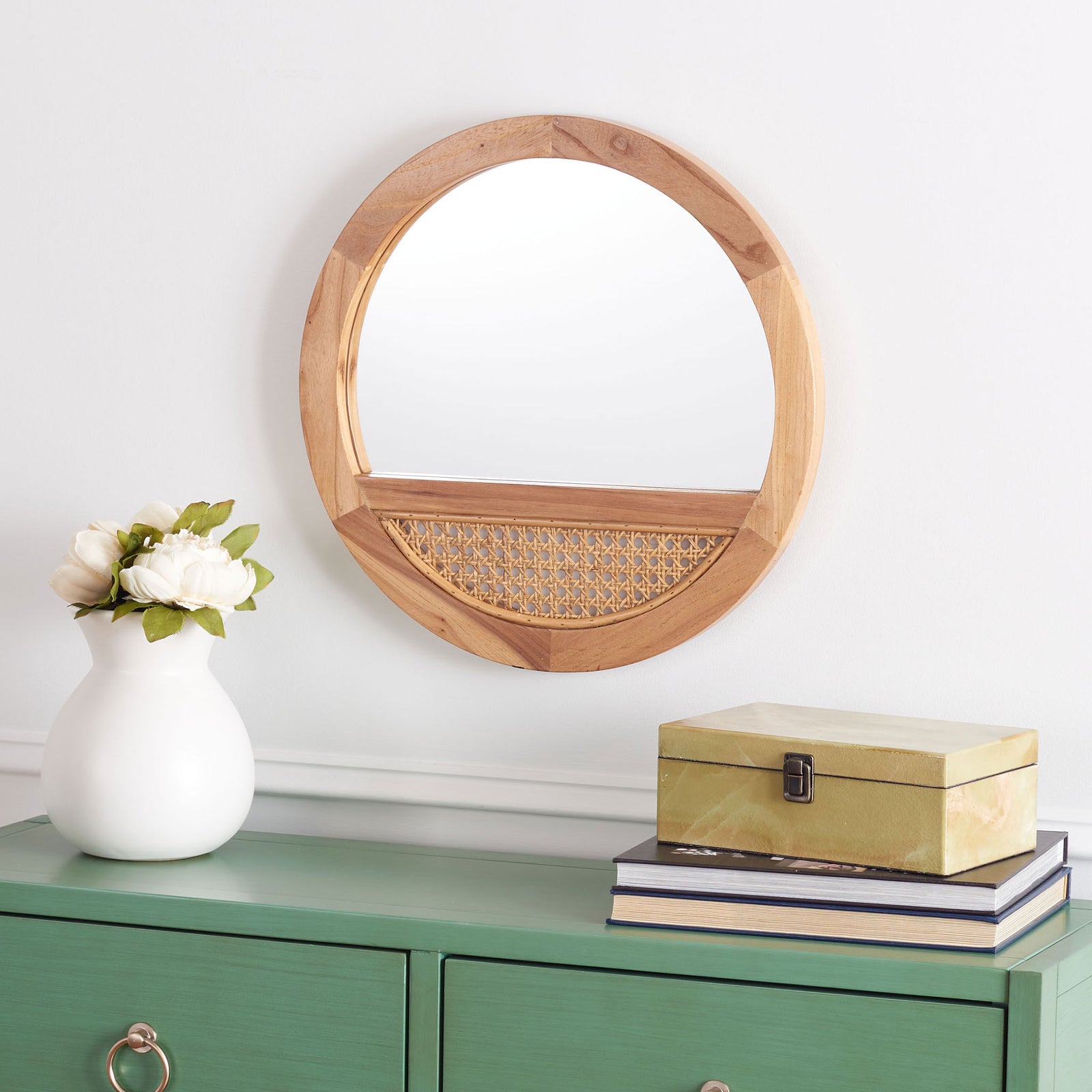 A round natural wood mirror with a woven cane accent brings warmth above a green cabinet. || MRR2015B || front_room