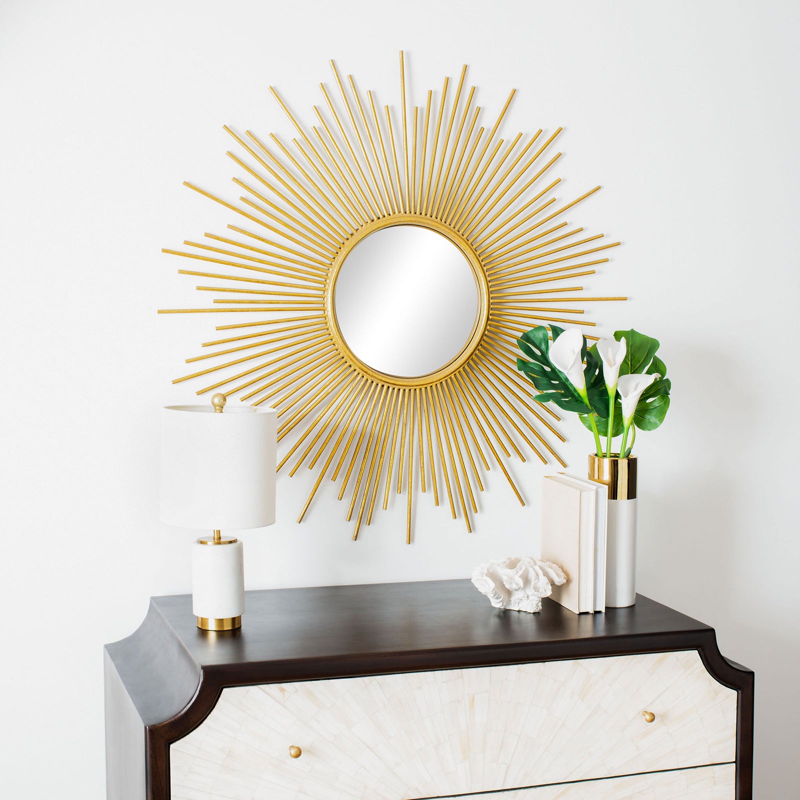 Radiating gold spokes brighten the wall above a dresser, creating a sculptural focal point || MRR3009A || front_room