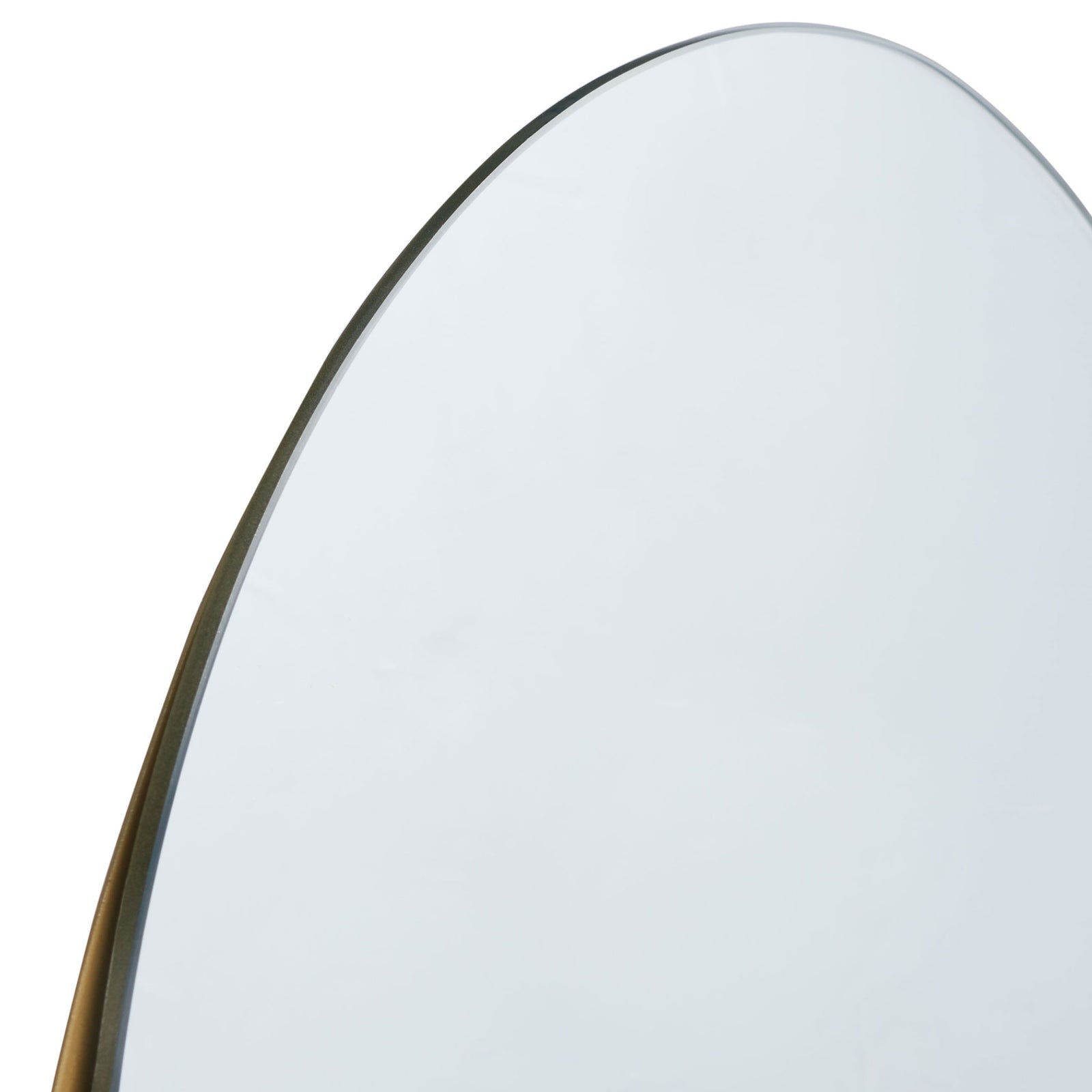 A slender brass frame traces the mirror's softly curved upper edge || MRR3063A || detail_studio