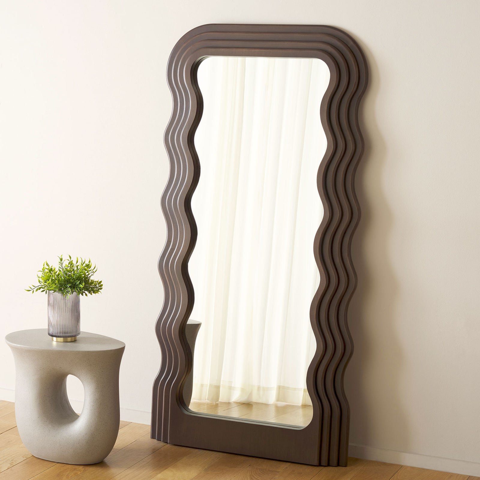 Rich walnut tones and rippling edges add warmth beside a neutral wall and accent table || MRR9006C || front_angle_room