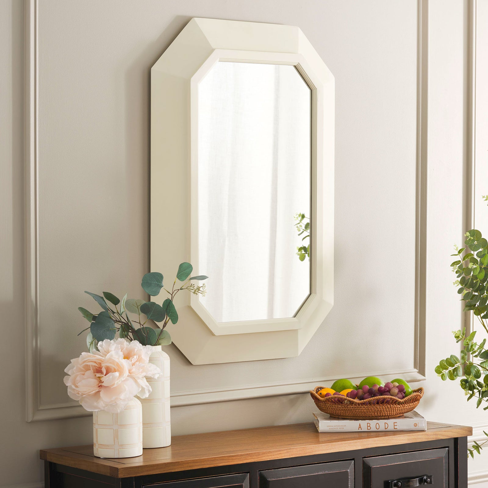 A white octagonal mirror brings soft geometric style above a wood-topped cabinet. || MRR9009A || front_angle_room