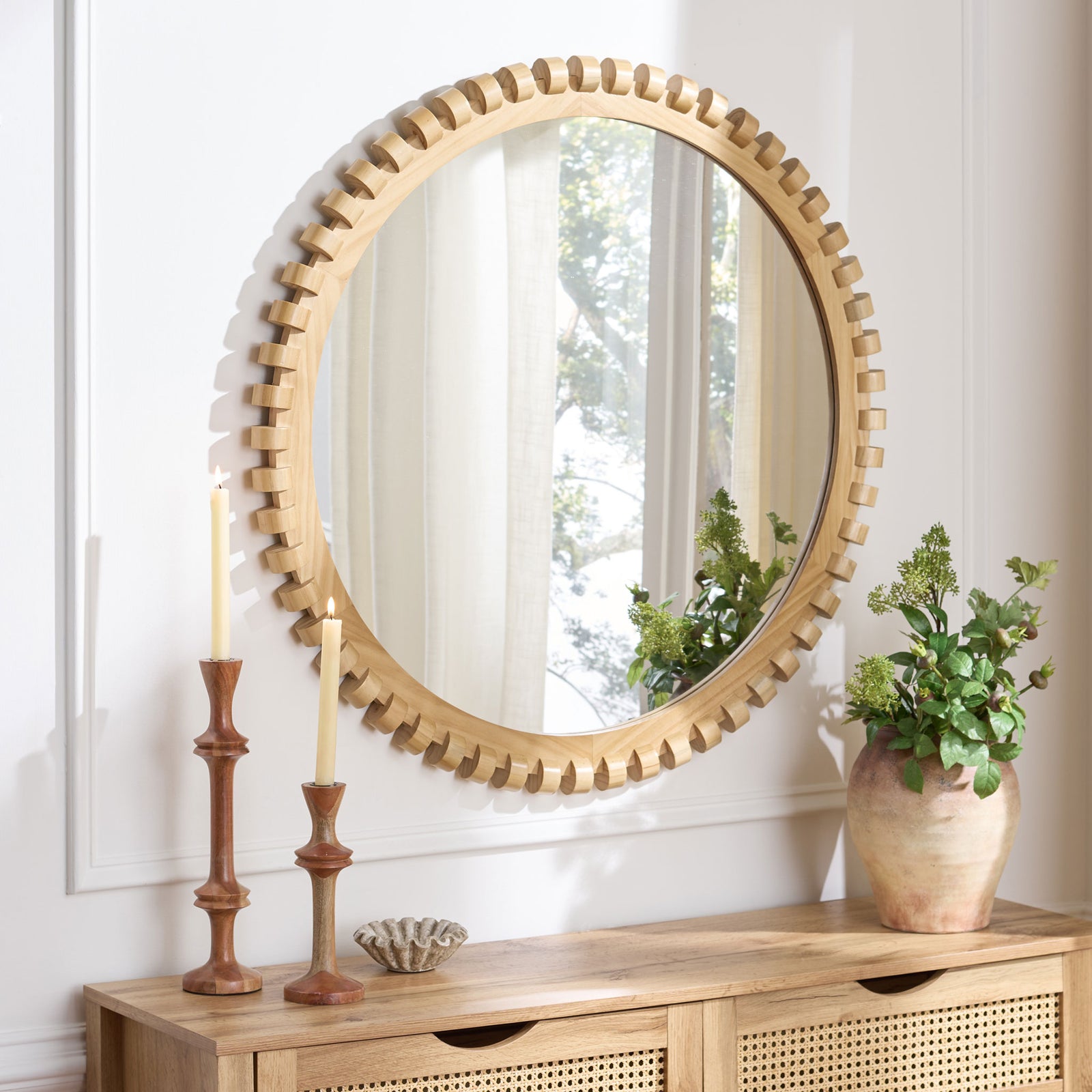 A natural wood-framed mirror brings warmth, sculptural texture, and reflected light above a console. || MRR9033A || front_angle_room