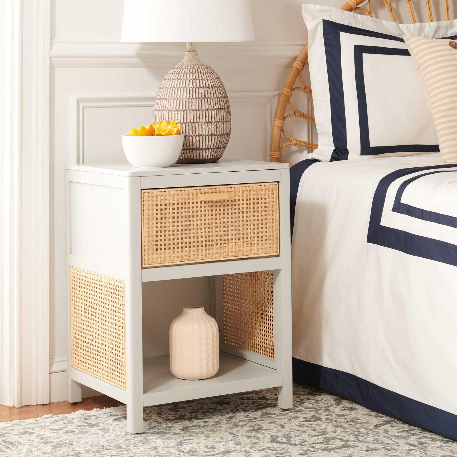 Relaxed coastal style blends gray wood and natural rattan for a warm, welcoming bedside accent. || NST5012D || front_angle_room