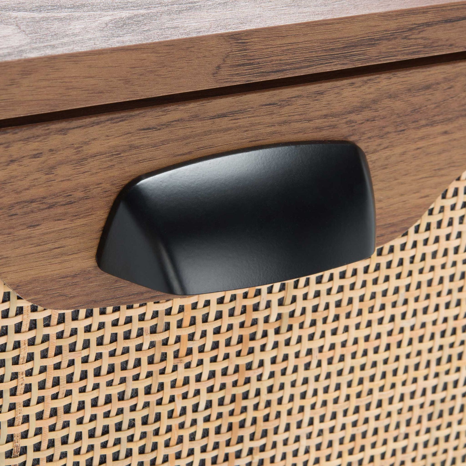 Matte black pull contrasts with airy rattan mesh for a modern, textured accent || NST9602A || handle_studio