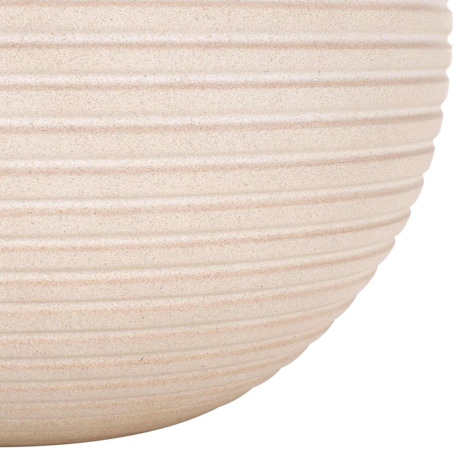 The beige planter's ribbed sides sweep inward to a gently rounded base. || PAT1534B || leg_studio