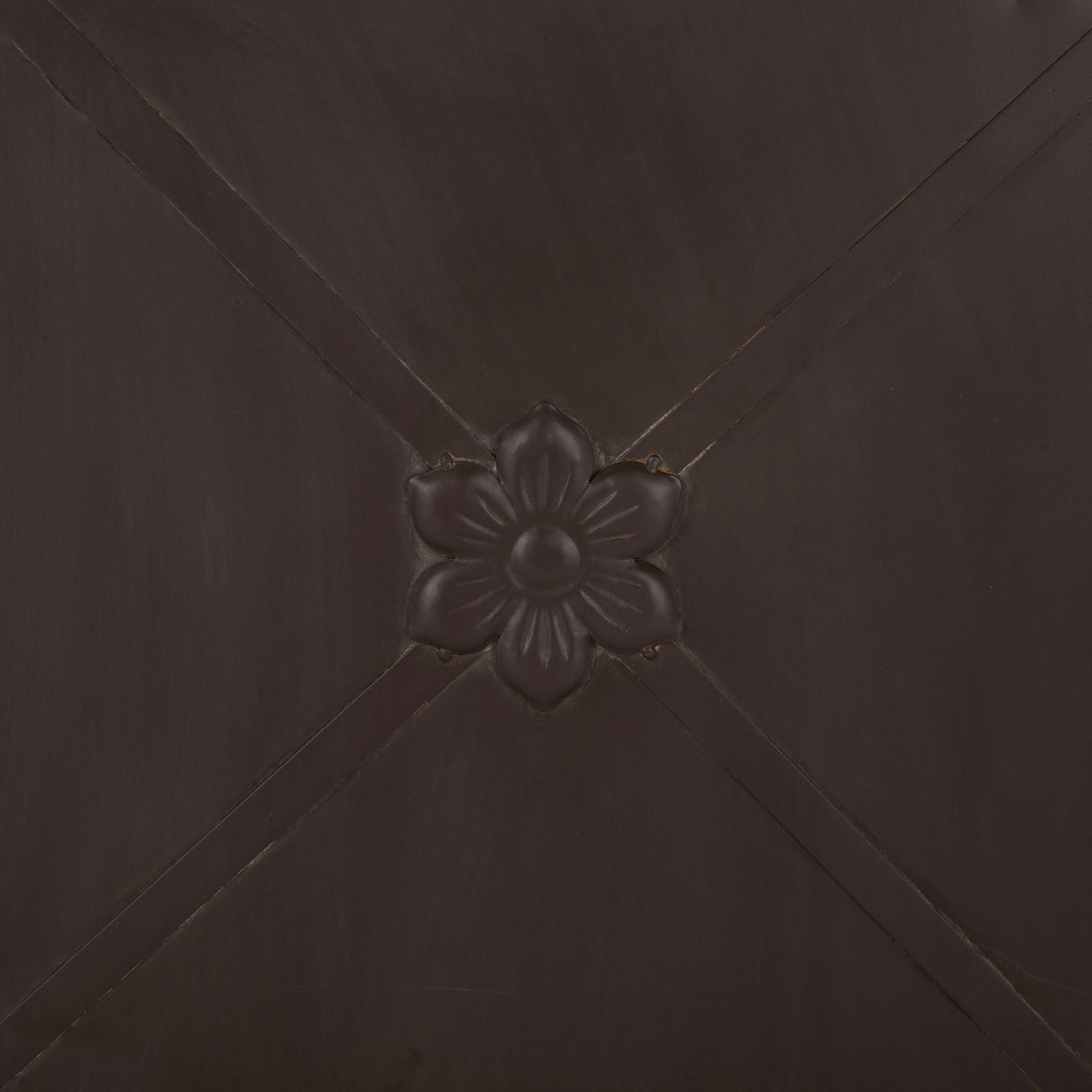 A sculpted flower punctuates the crossed iron bands on the rustic brown planter. || PAT5048B || detail_studio