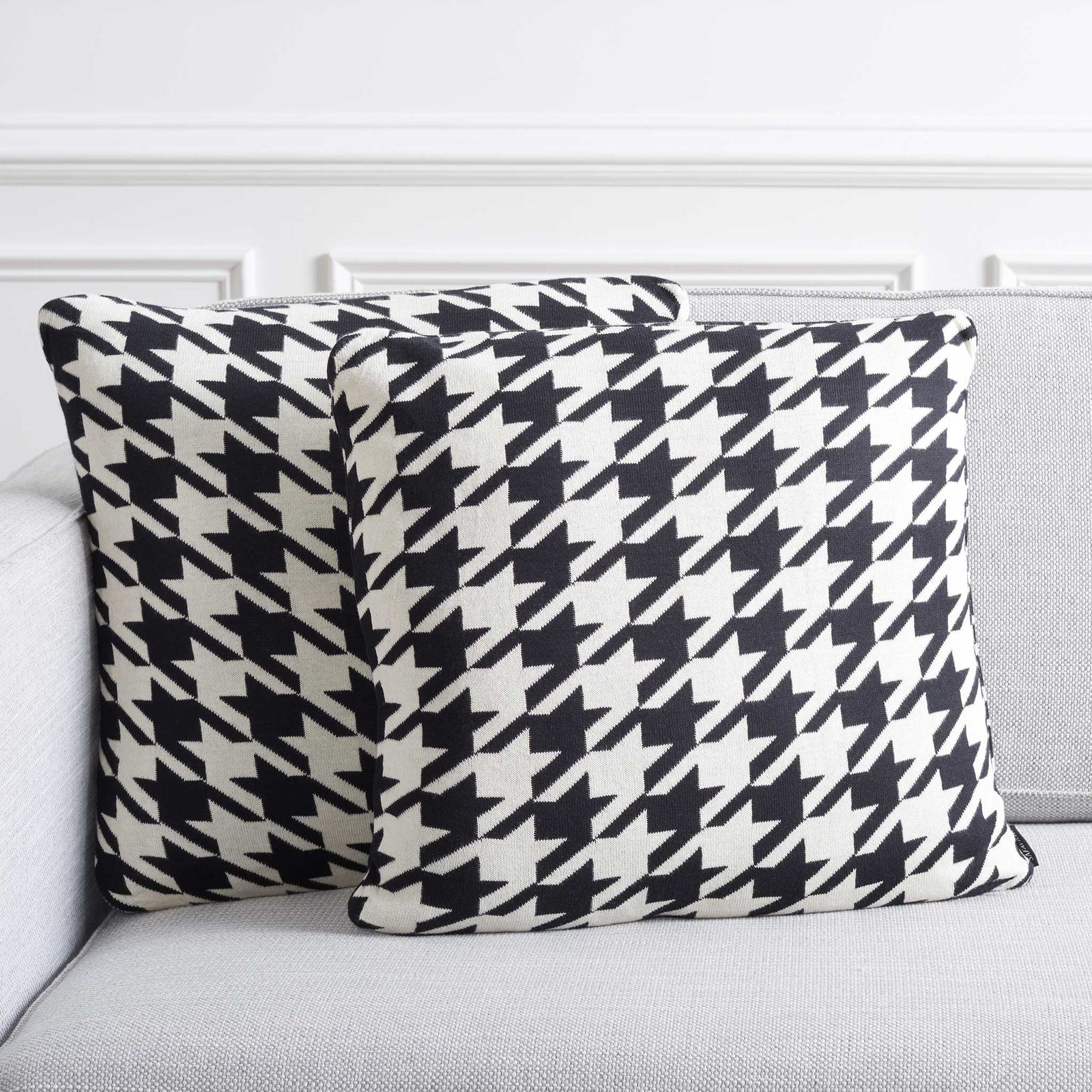 Set of two houndstooth pillows brings crisp black and ivory contrast to a modern sofa || PLS400A-1818-SET2 || front_angle_multi_room