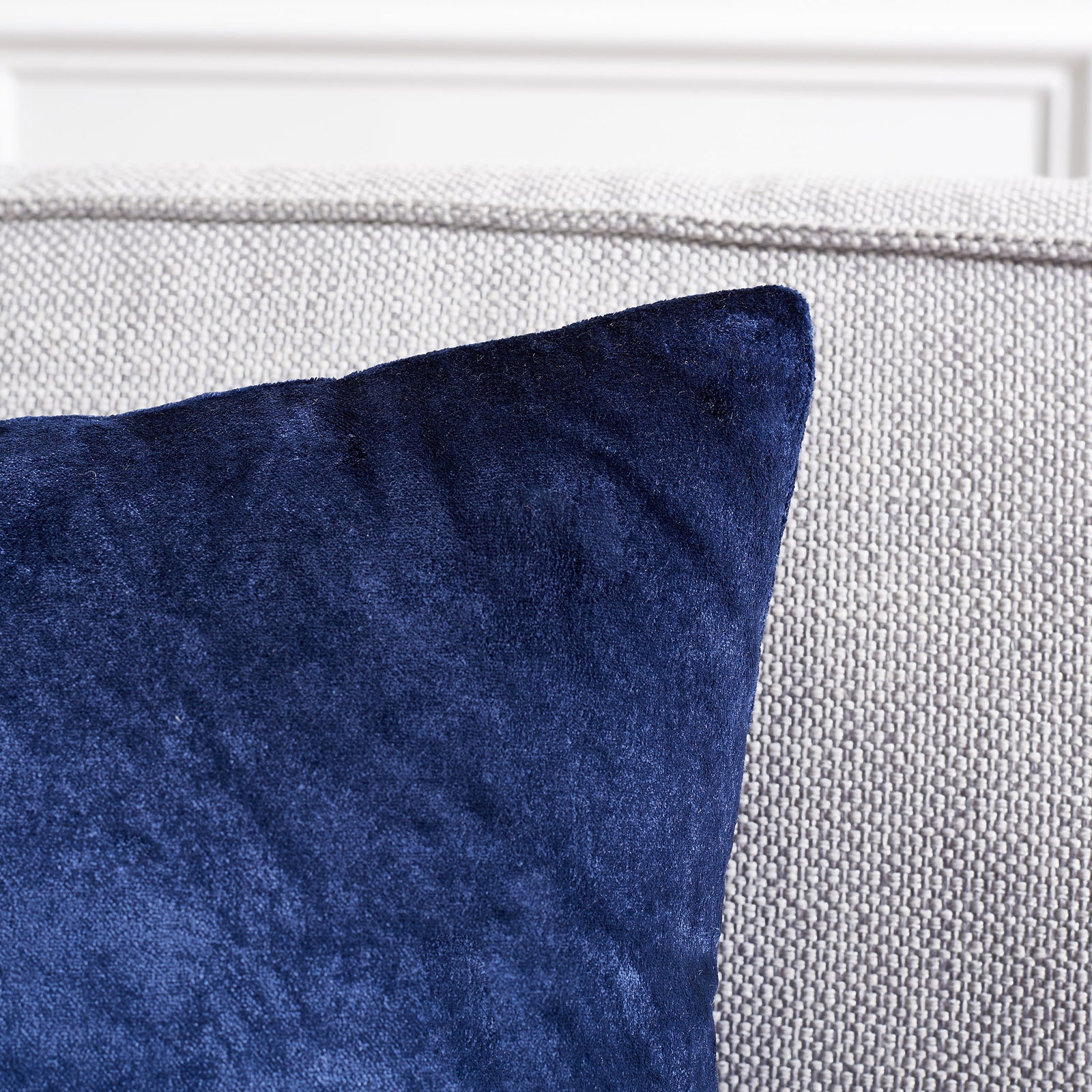 Deep navy fabric catches the light beside a softly finished pillow edge. || PLS500C-1818-SET2 || detail_room