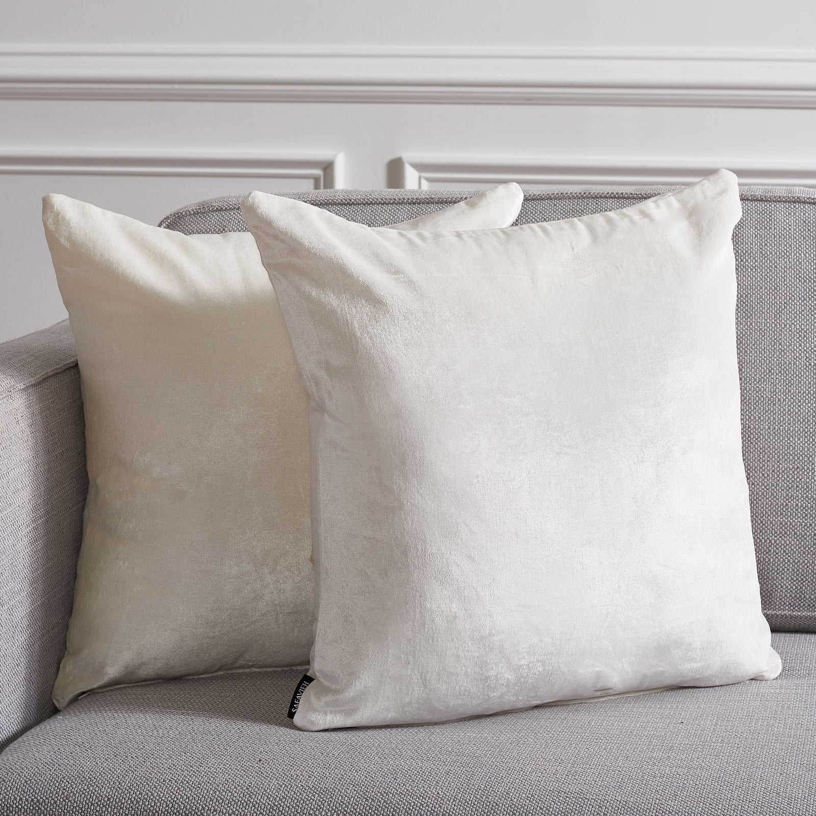 A pair of ivory pillows adds soft texture and a warm glow to a gray sofa || PLS503A-1818-SET2 || front_multi_room