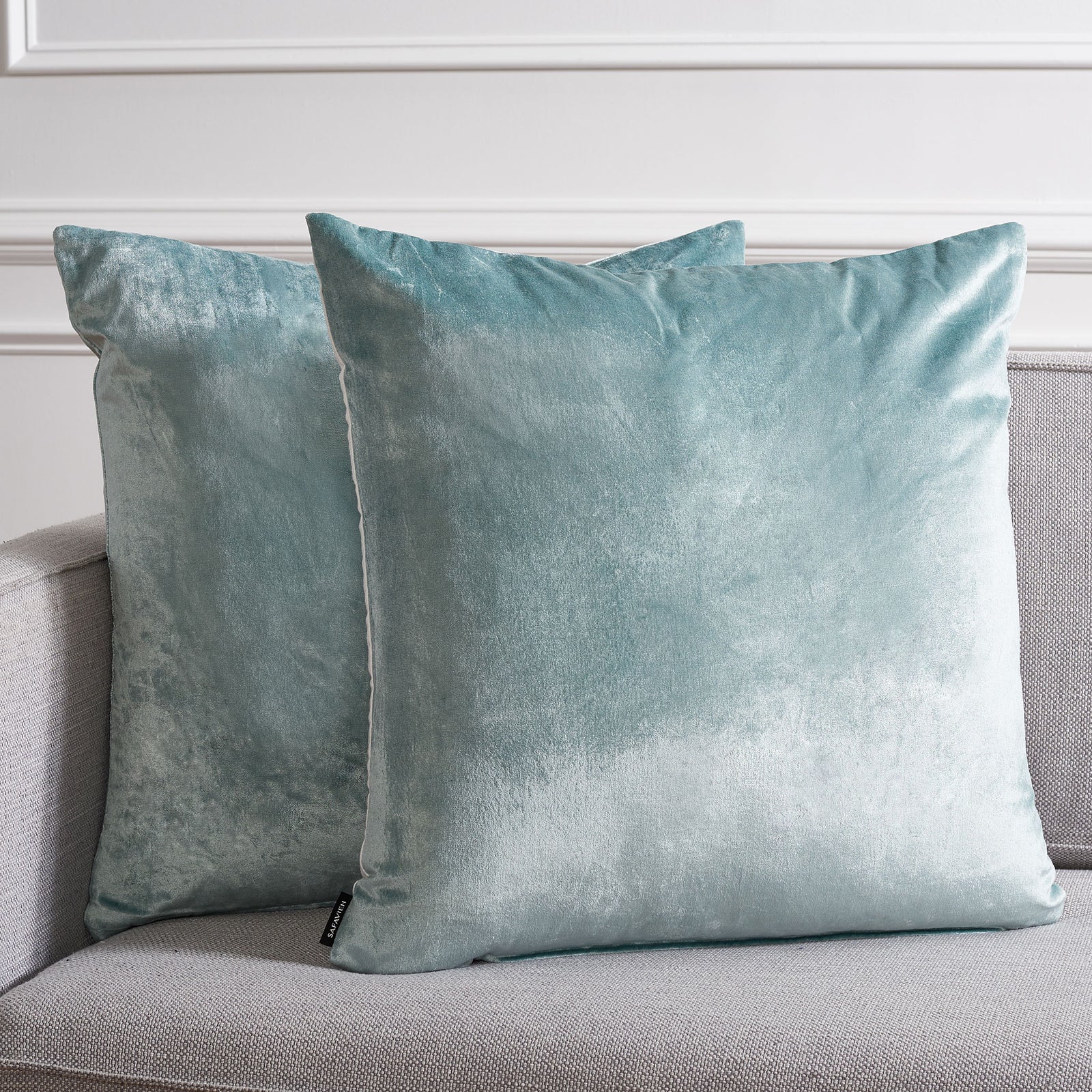 Two large aqua pillows lend a luminous, cool-toned accent to neutral upholstery || PLS503B-2222-SET2 || front_multi_room