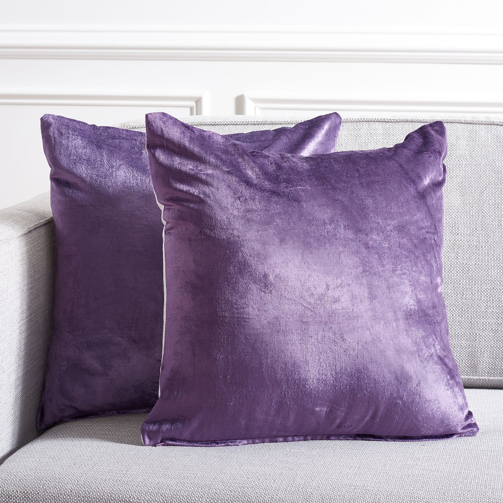 Two luminous purple pillows add a bold, cozy accent to pale upholstered seating || PLS503E-1818-SET2 || front_multi_room