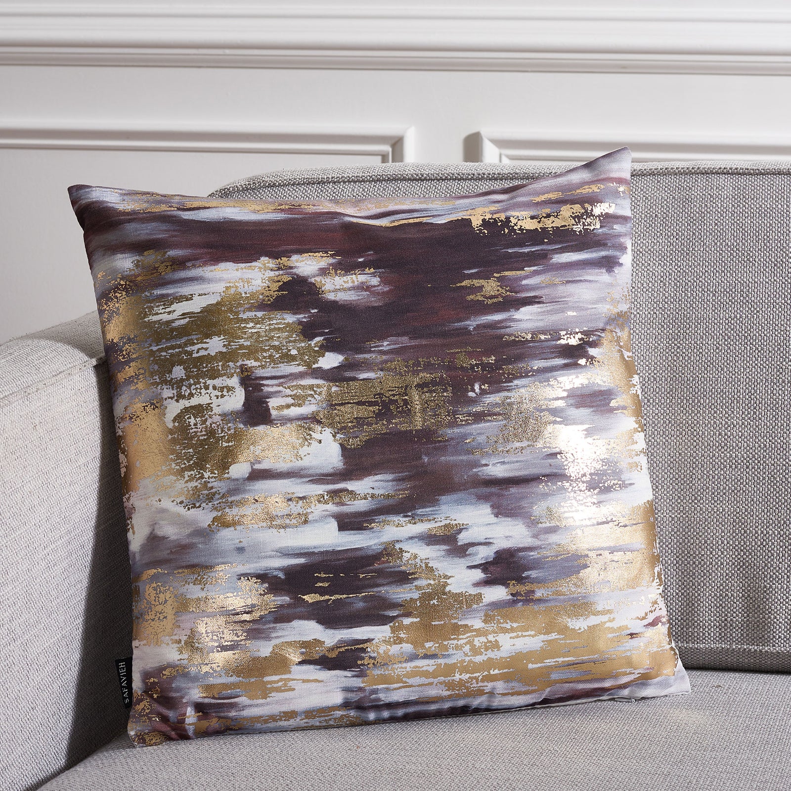 An abstract navy, gray and gold pillow brings a glamorous touch to a neutral sofa. || PLS7197C-1818 || front_room
