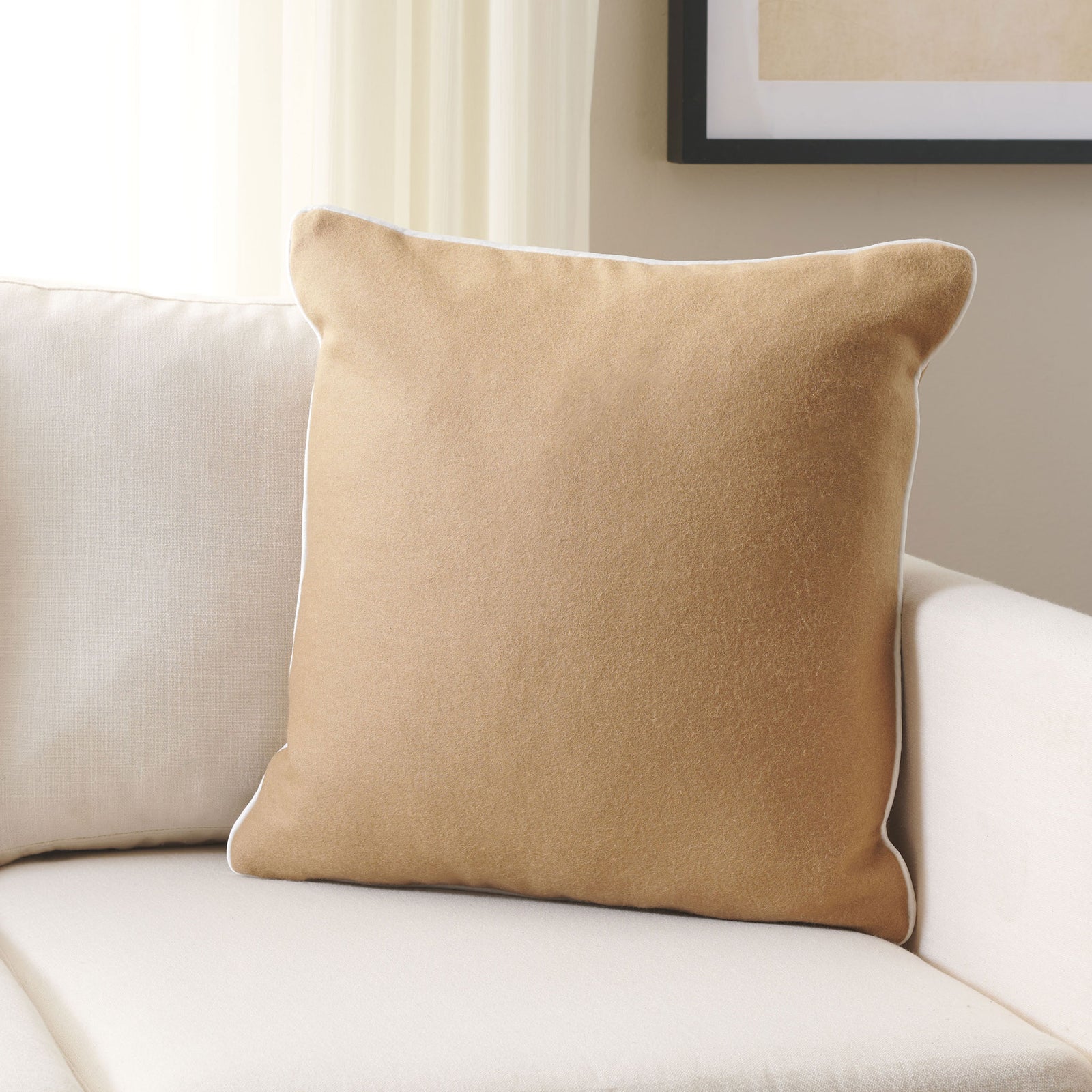 A camel wool accent pillow brings cozy texture and subtle contrast to a pale sofa. || PLS7223B-1818 || front_room