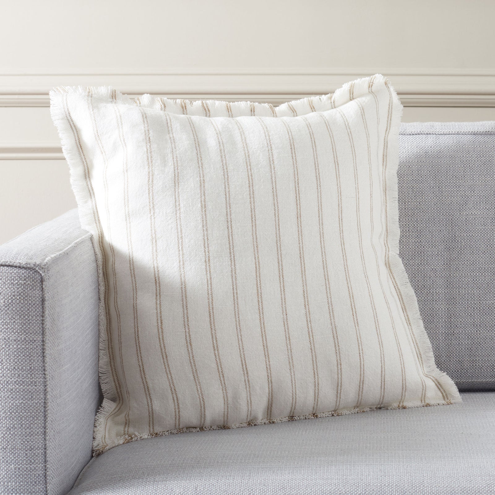 An ivory striped linen pillow brings relaxed texture and comfort to a sofa || PLS8007A-2020 || front_angle_room
