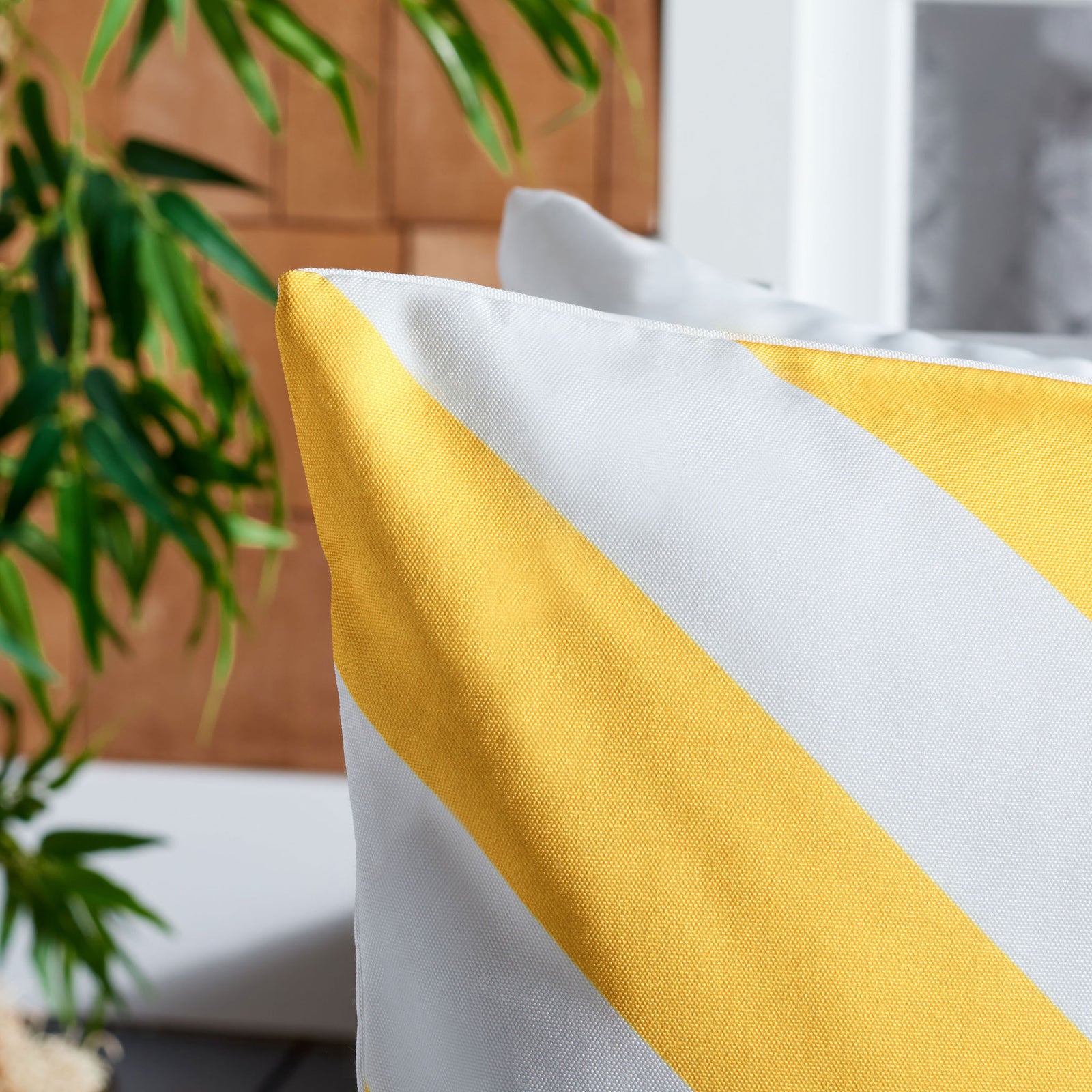 Sunny yellow and white diagonal bands reveal the pillow's fine fabric weave. || PPL262E-1818 || detail_room