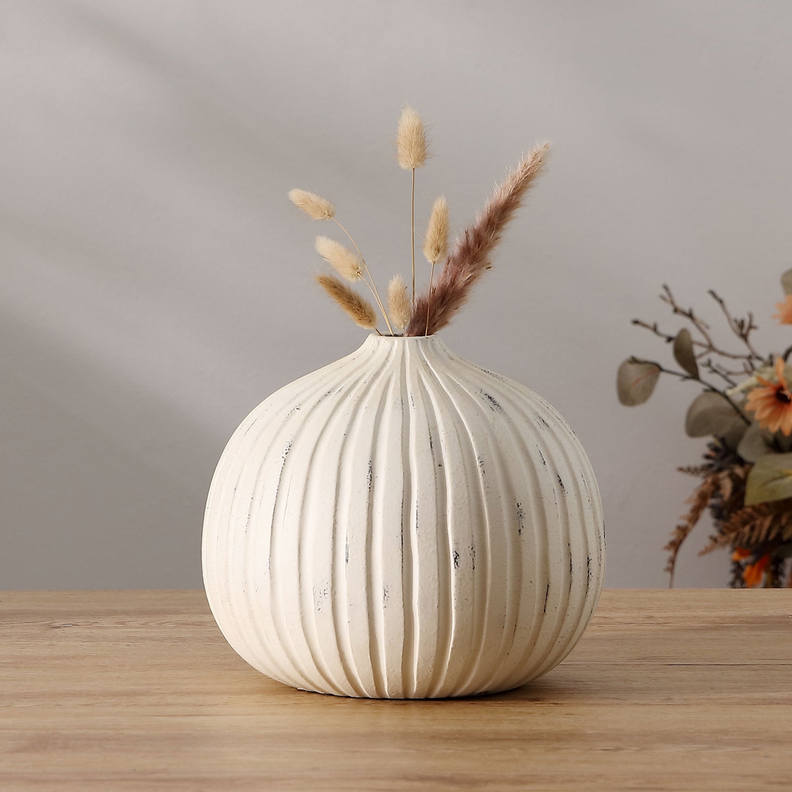 Distressed white vase with flowing grooves brings texture to a display of dried stems || RDC4032A || front_room