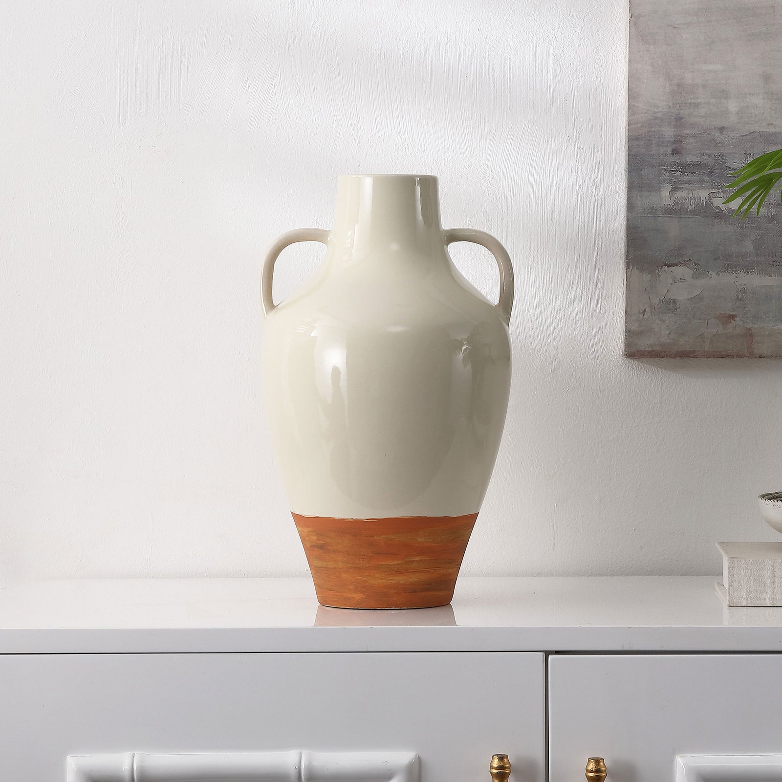 Twin loop handles and an earthy brown base make the glossy ivory vase a warm decorative accent. || RDC4062A || front_room