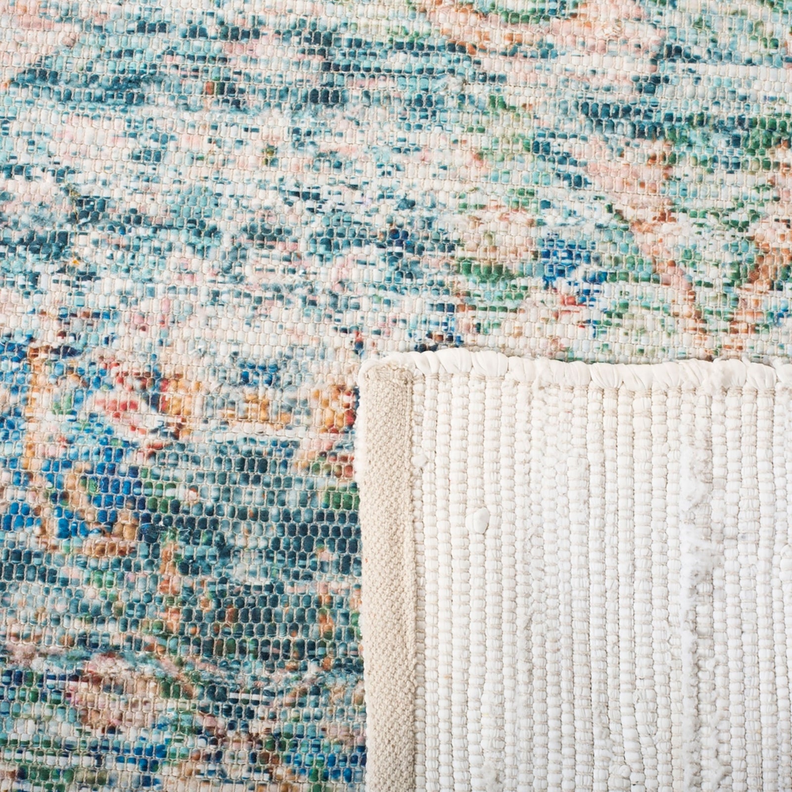 Turquoise and peach rug with folded white backing revealing its woven construction || SFN563A-5 || backing_studio