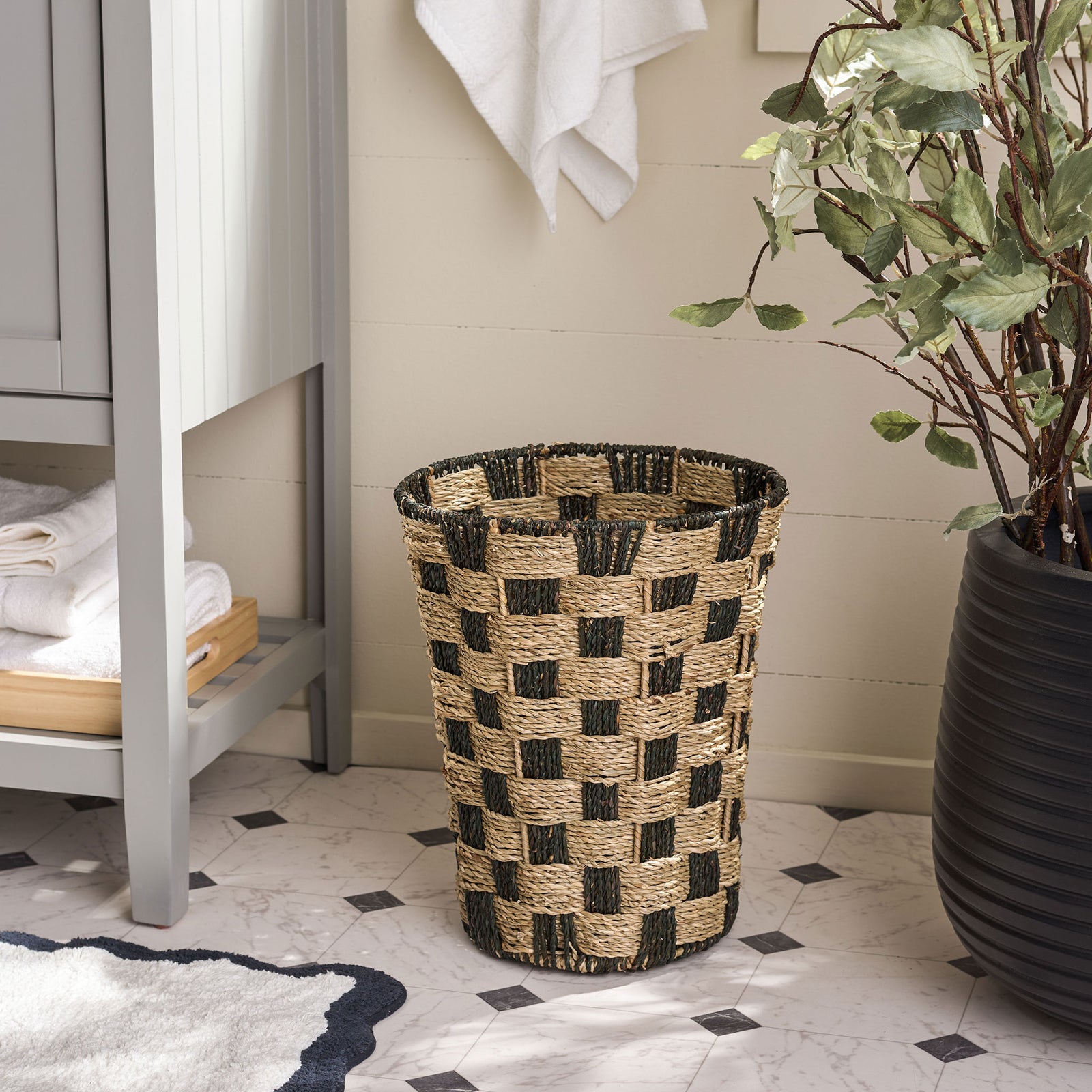 Textured seagrass basket brings checkerboard style and practical storage to a bright bathroom || STG1824A || front_room