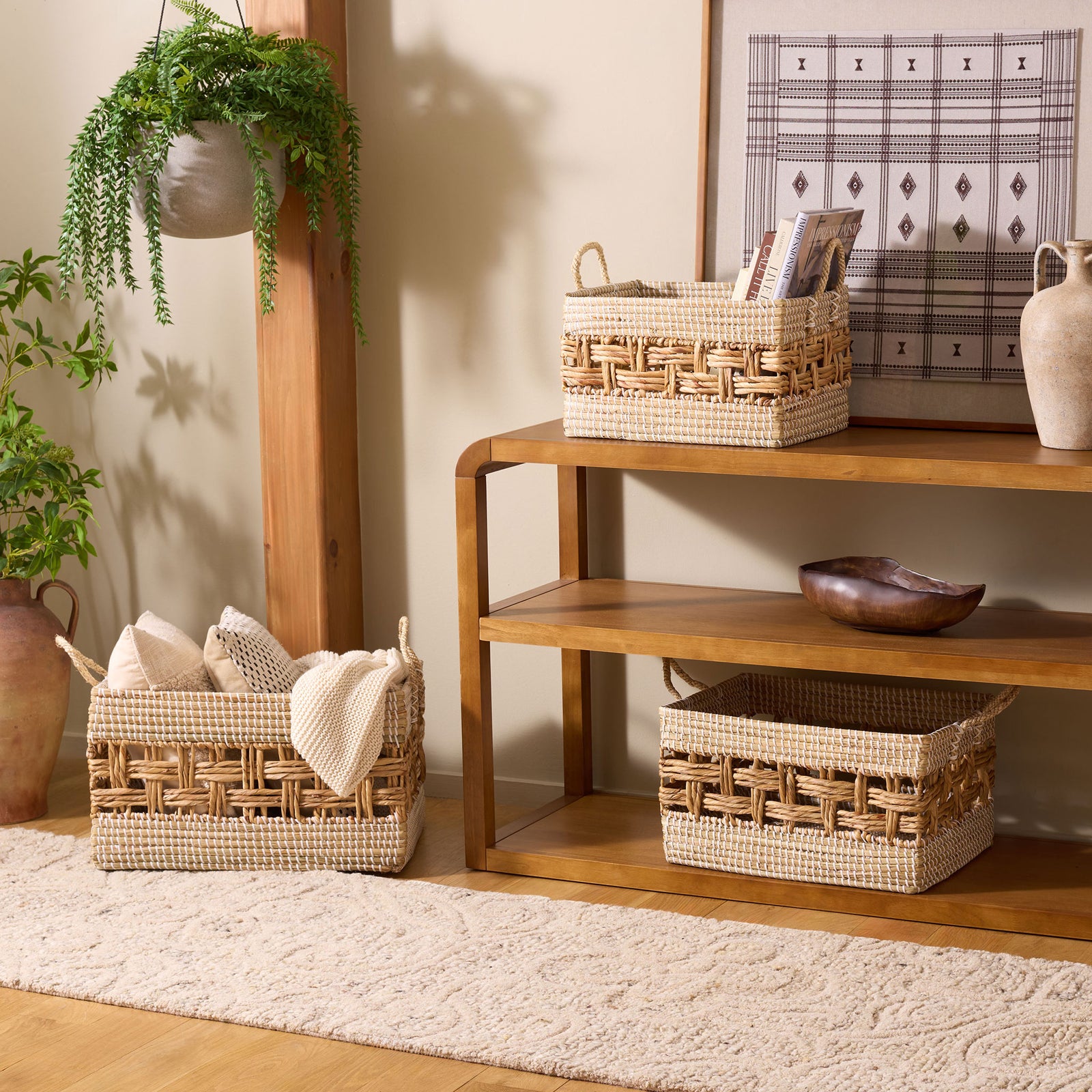 Three natural woven baskets with openwork bands organize books and textiles while adding warm texture || STG1834A-SET3 || front_angle_room
