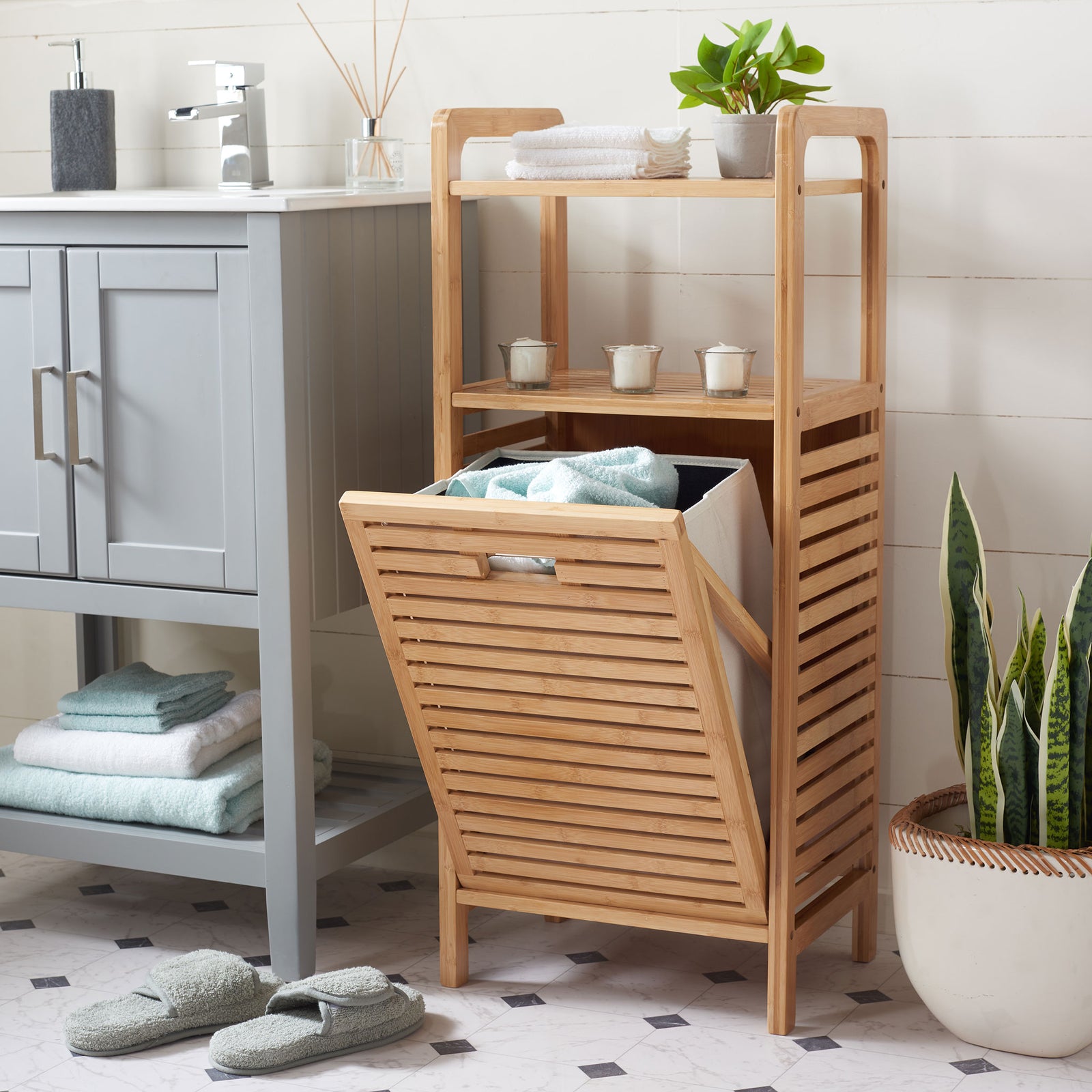 A pull-down hamper holds towels below bamboo shelves displaying bath essentials and greenery || STG1903A || front_angle_open_room