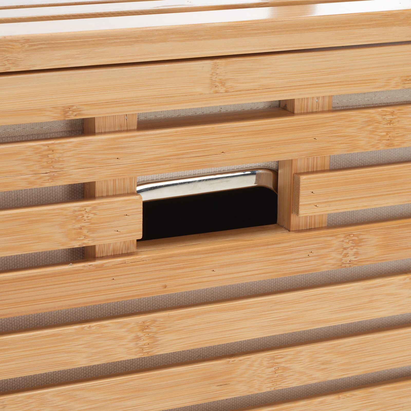 A recessed grip blends into the warm bamboo slats for easy access to the laundry basket || STG1903A || handle_studio
