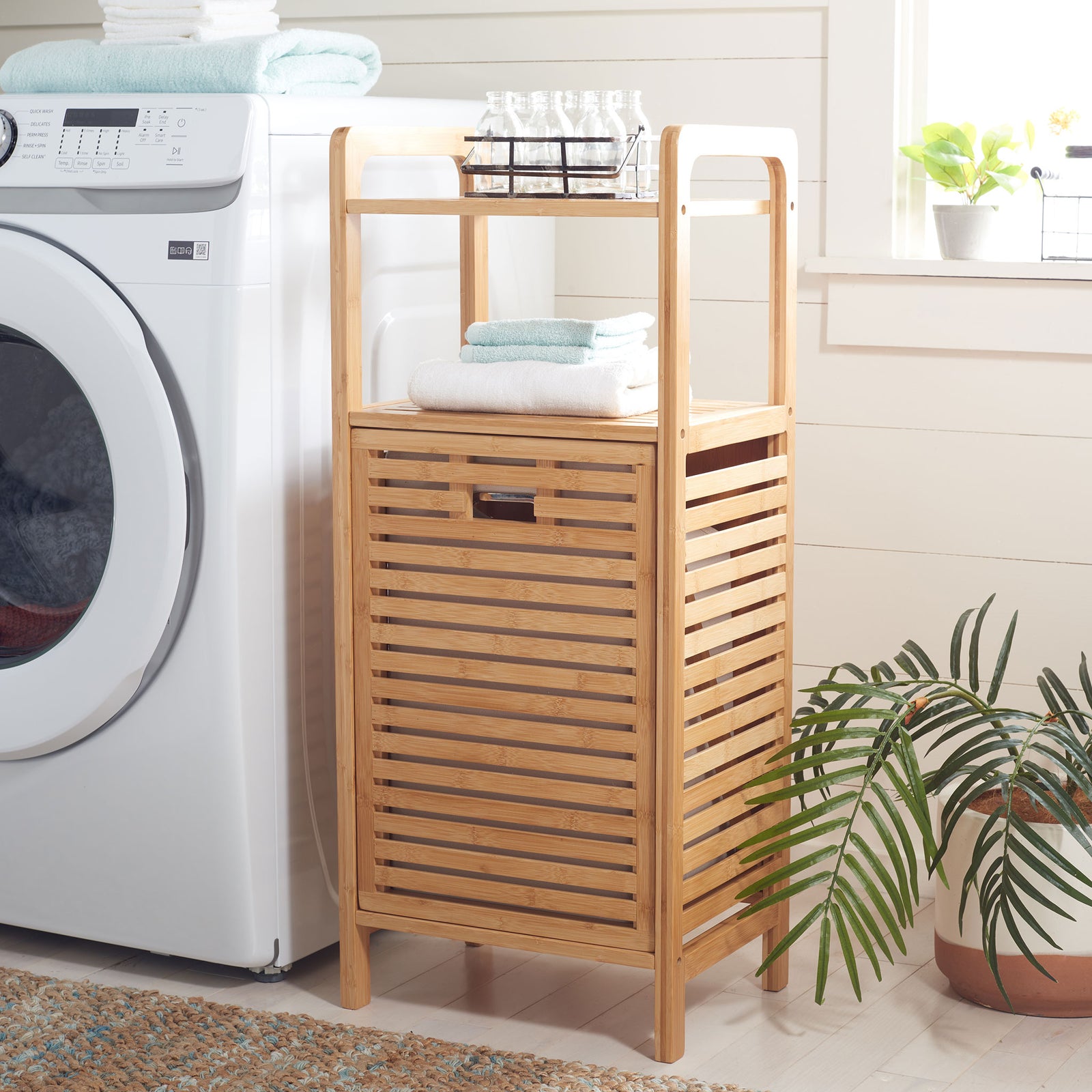 Two open shelves keep towels and essentials handy above a slatted hamper that tucks away laundry || STG1903A || front_angle_room