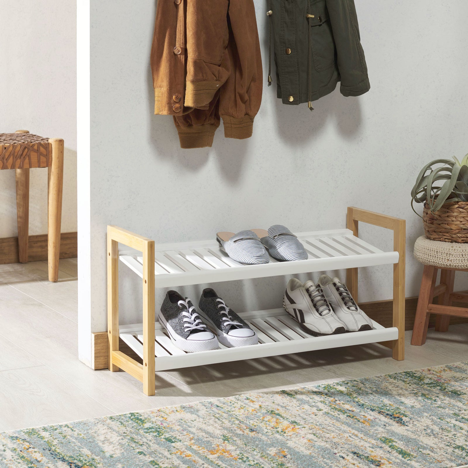 White slatted shelves and bamboo supports keep several pairs of shoes tidy in an entryway. || STG1909A || front_angle_room