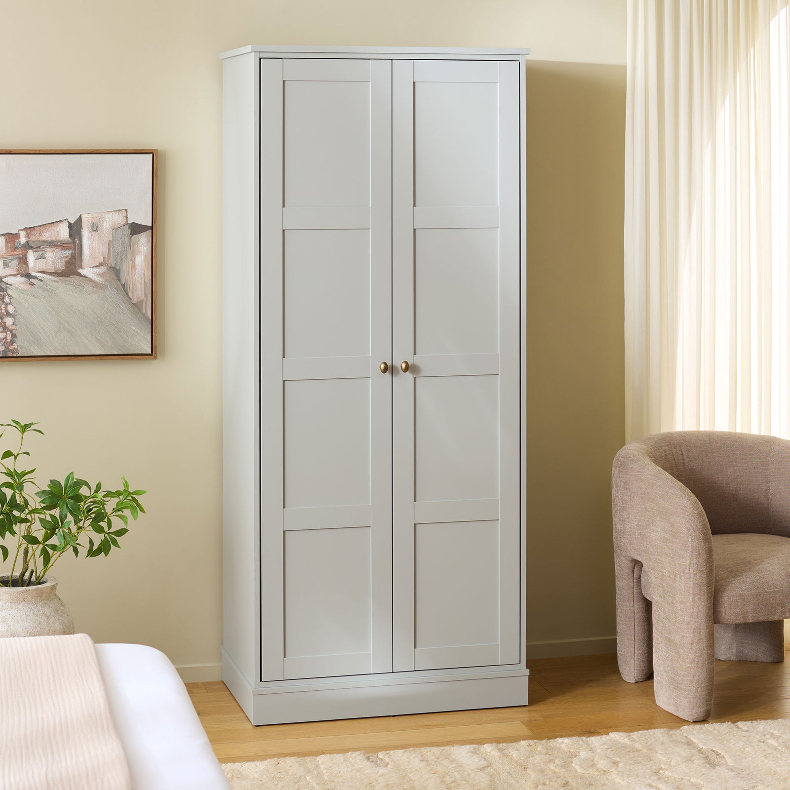 Light gray paneled wardrobe adds tidy clothing storage to a softly furnished bedroom. || STG3102A-2BX || front_angle_room