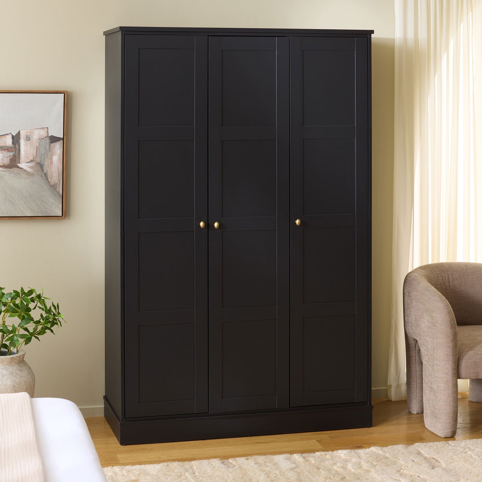 Three-door black wardrobe brings ample enclosed storage to a bright, neutral bedroom. || STG3103C-3BX || front_angle_room