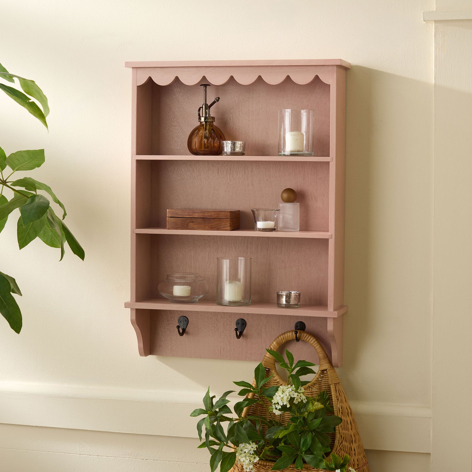 Blush pink shelves display candles and accents while a woven basket hangs from a hook || STG5702E || front_room