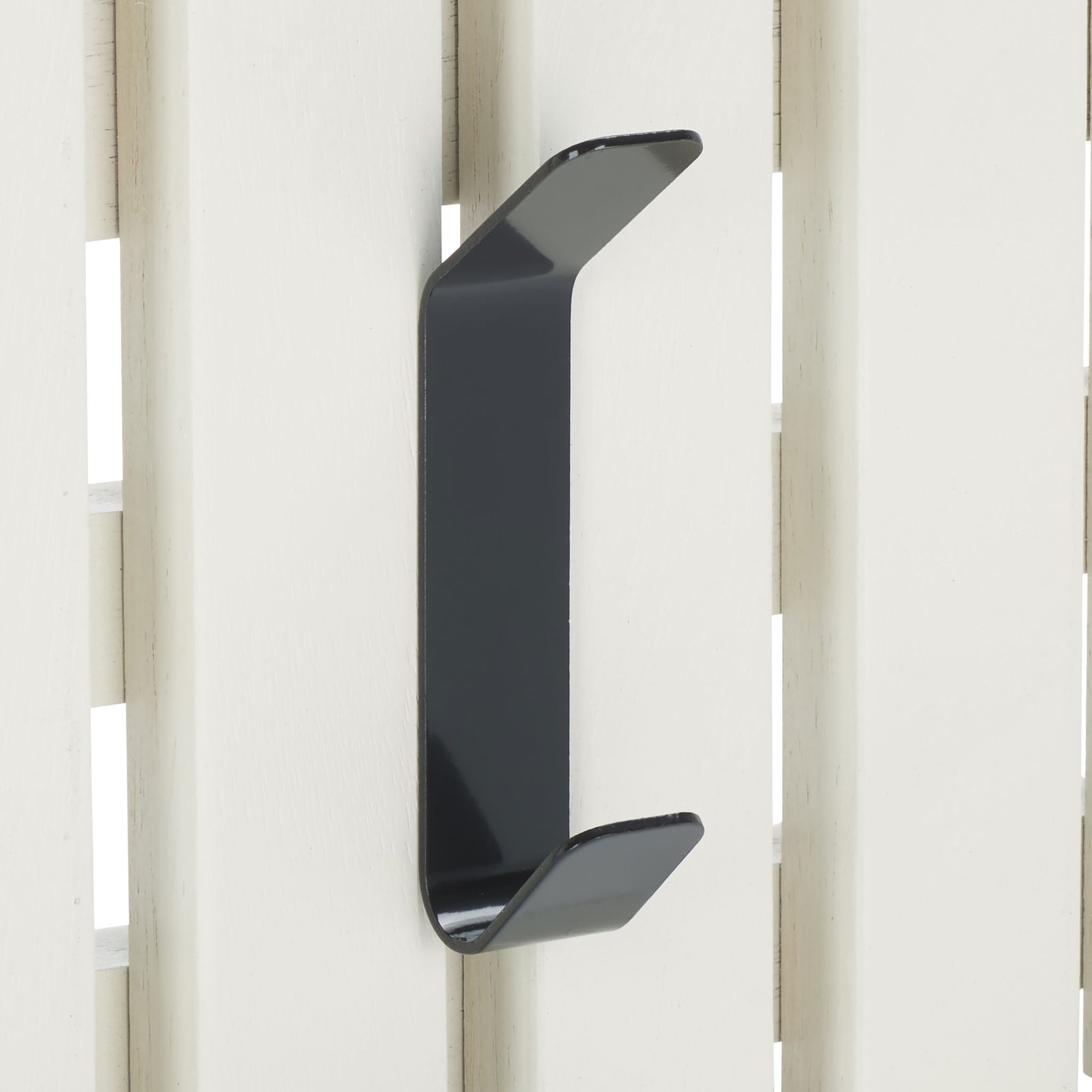 A black double hook stands out against clean white wood slats, adding two spots for hanging essentials. || STG5704C || detail_studio