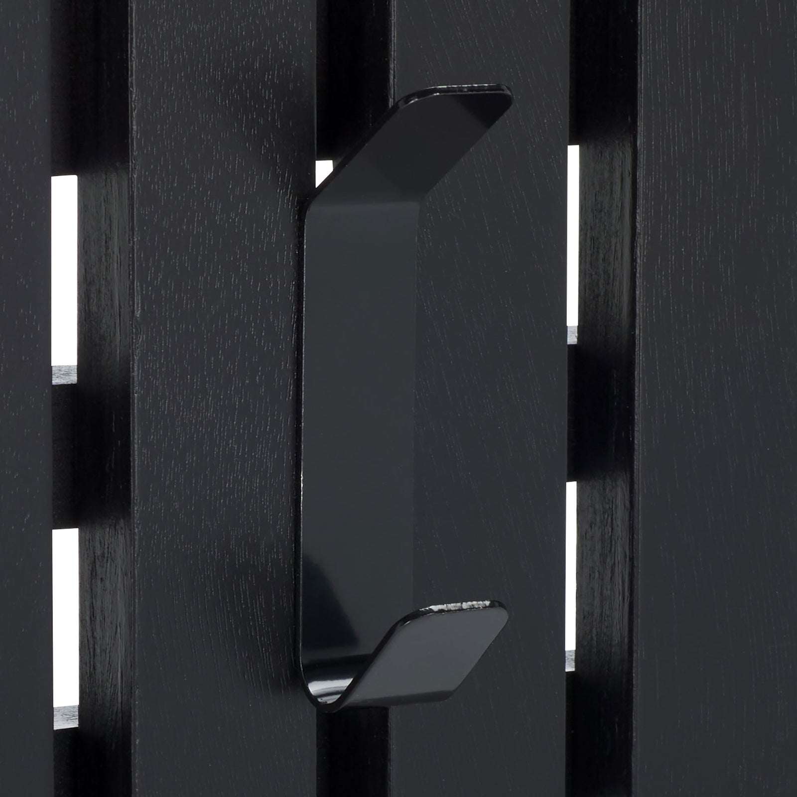 A curved black double hook adds two useful hanging points against sleek black wood slats. || STG5704E || detail_studio