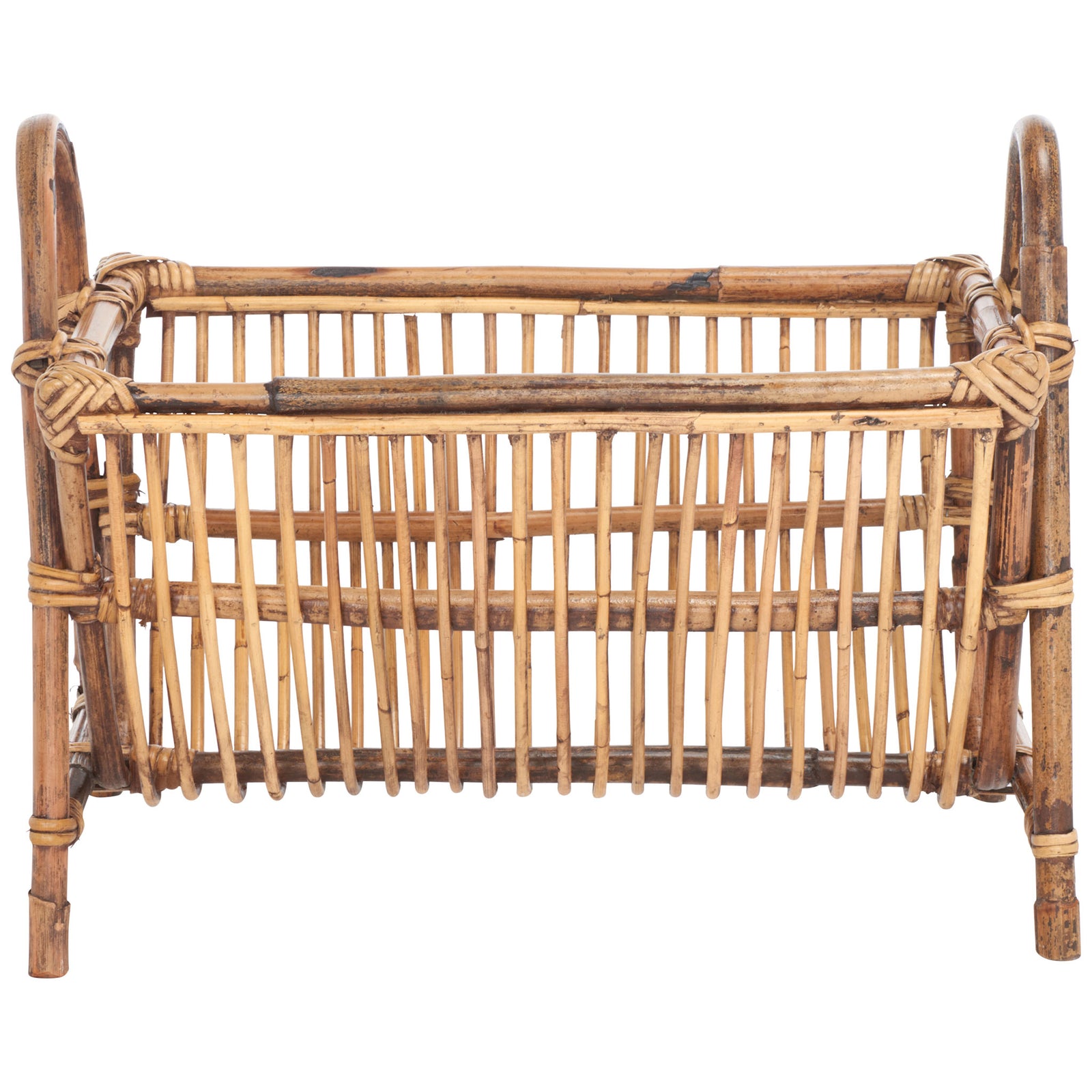 An open rattan newspaper rack pairs a slatted cradle with curved handles and sturdy legs || STG6500A || front_studio
