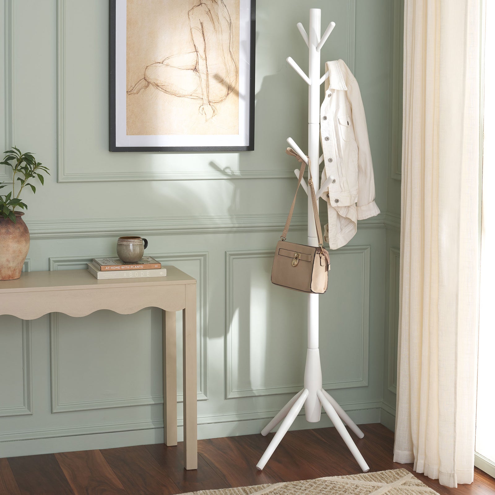 Whitewashed coat stand holds a jacket and handbag beside a light console table || STG8500C || front_room