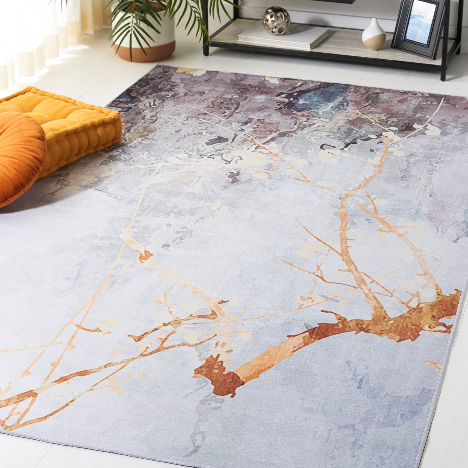 Statement area rug brings artful gray tones and warm branch motifs to a bright living space || TAC811F-5 || top_angle_room