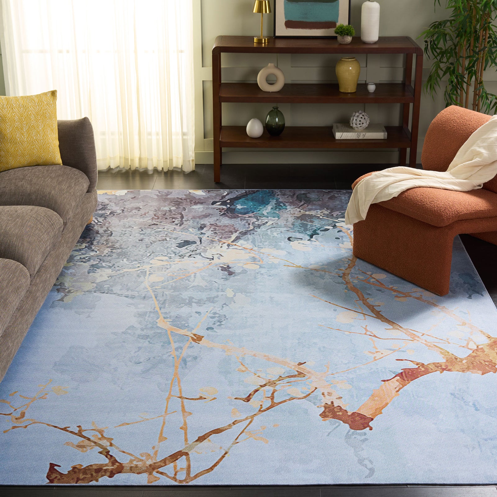 Modern rug anchors a living room with airy grays, soft beiges, and coppery branch accents || TAC811F-8 || top_angle_room