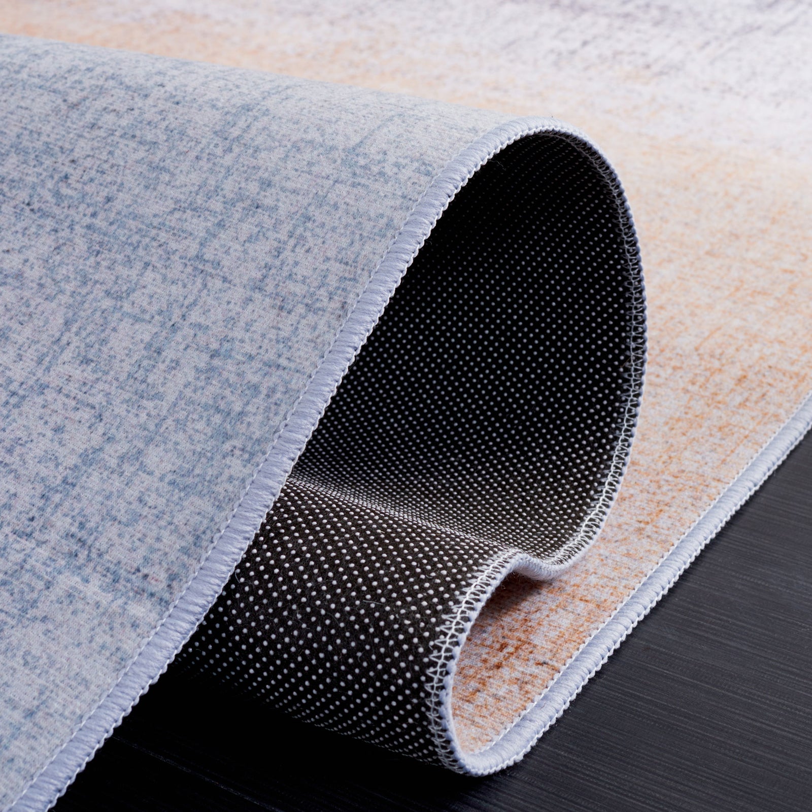 Flexible rug shows slip-resistant dotted backing || TAC816F-5 || backing_studio