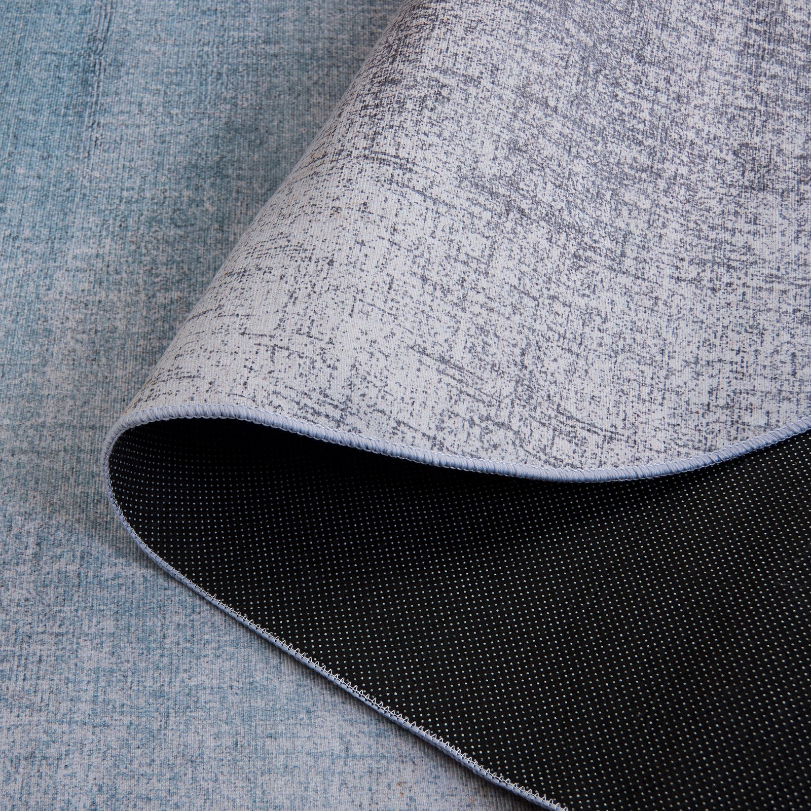 Folded corner reveals grippy, non-slip backing with a neatly stitched edge. || TAC816F-5OV || backing_studio