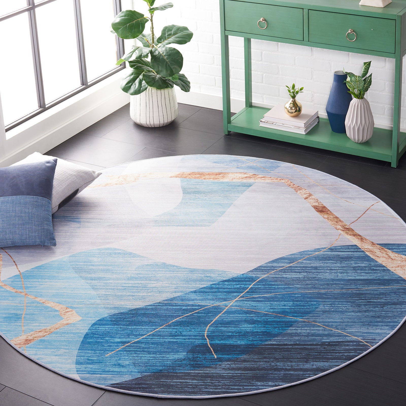 Round rug with sweeping gold lines over tonal blues for a modern, artful focal point. || TAC836M-6R || front_angle_room