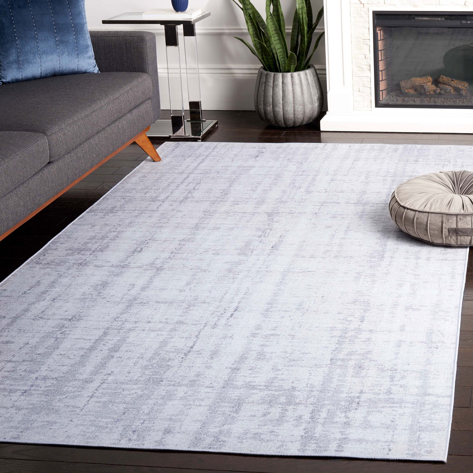 Light gray abstract rug grounds the space with modern texture and easy, family-friendly care. || TAC857F-5 || front_angle_room