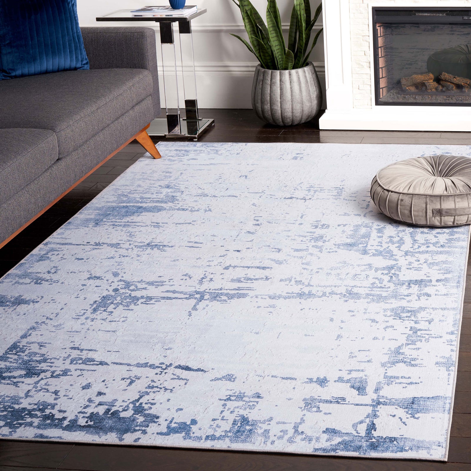 Modern gray and navy rug adds a soft, distressed layer that brightens the living space || TAC864F-5 || top_angle_room