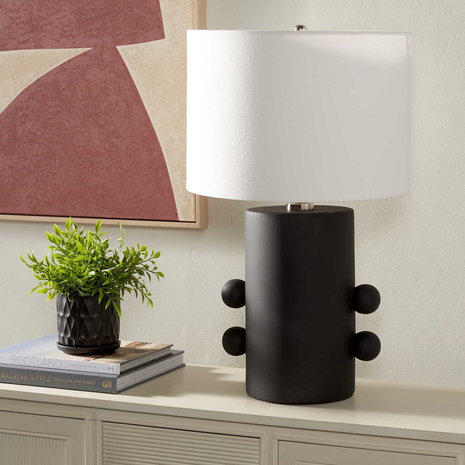 Bold black ceramic lamp adds sculptural texture, paired with a crisp off-white shade for modern contrast. || TBL2008A || front_angle_room