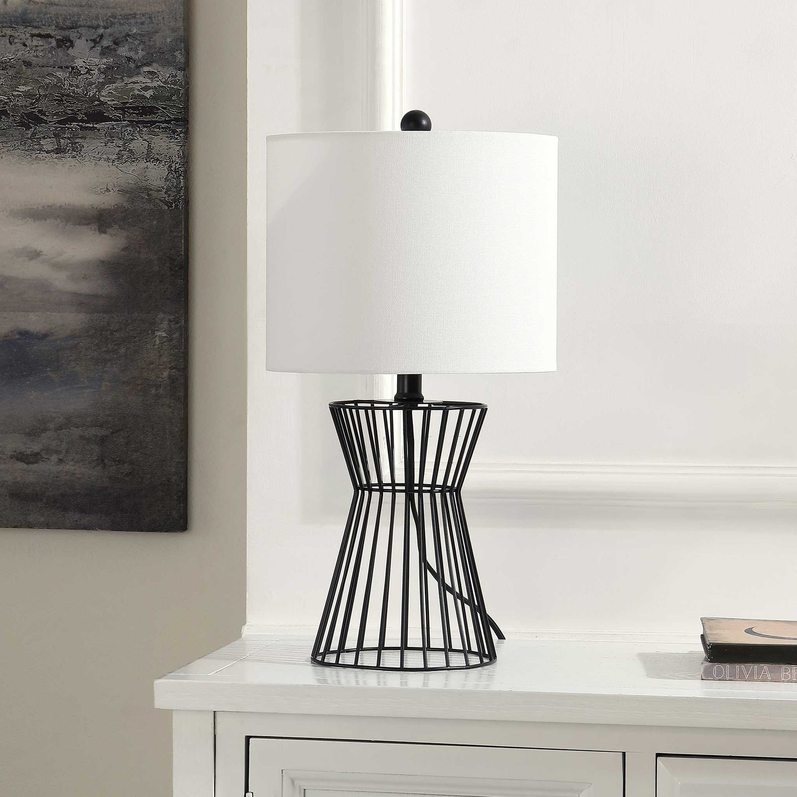 Sculptural black iron lamp with crisp white shade adds modern polish to consoles and nightstands || TBL4471A || front_angle_room