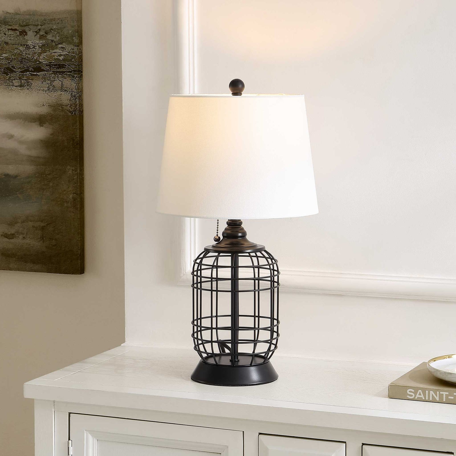 White shade glows warmly above a black openwork base, adding cozy character to the room || TBL4490A || front_angle_on_room