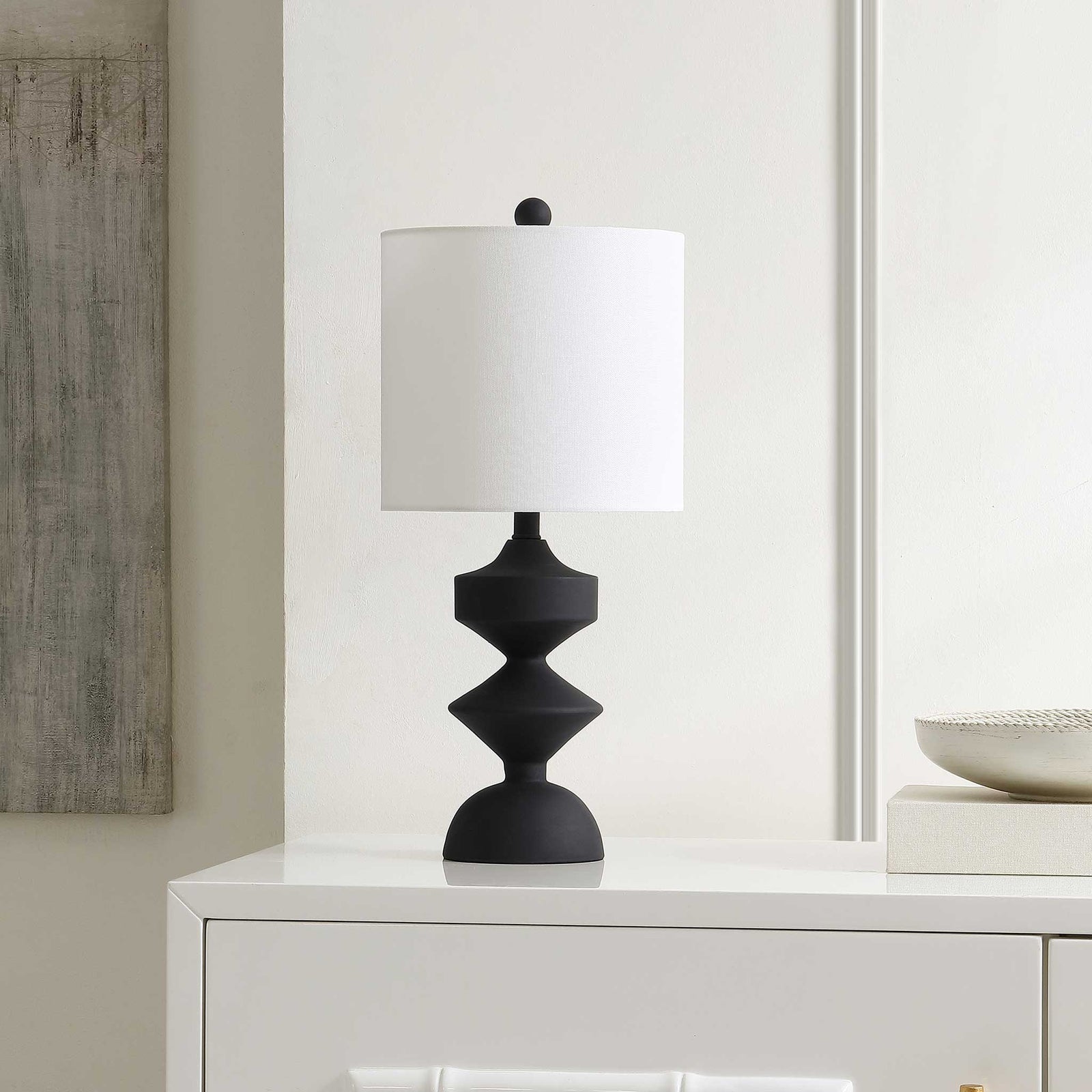 Modern black resin table lamp complements streamlined decor with a bright white shade || TBL4501A || front_angle_room