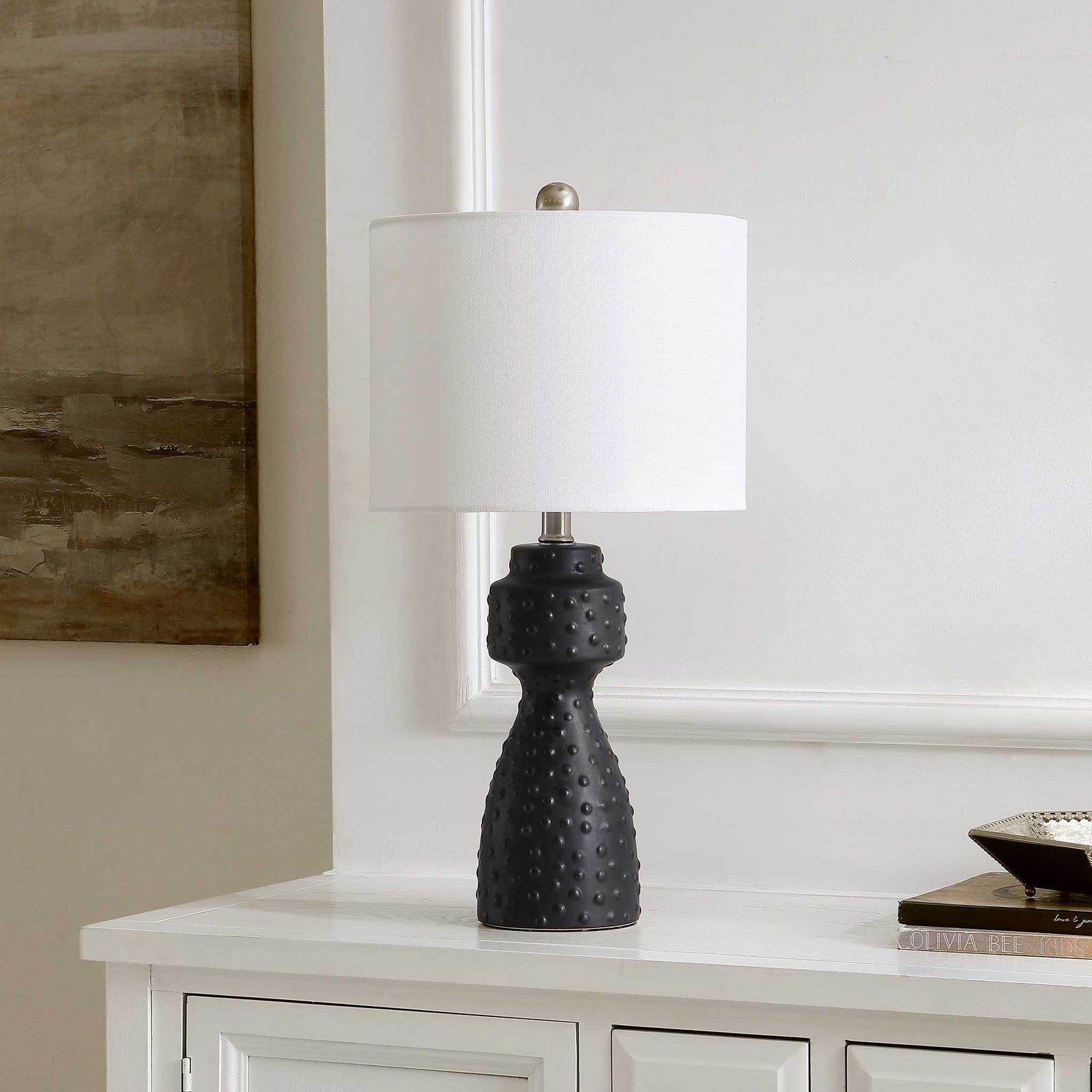 Sculptural black ceramic lamp with studded texture and white shade adds modern polish to decor || TBL4511A || front_angle_room